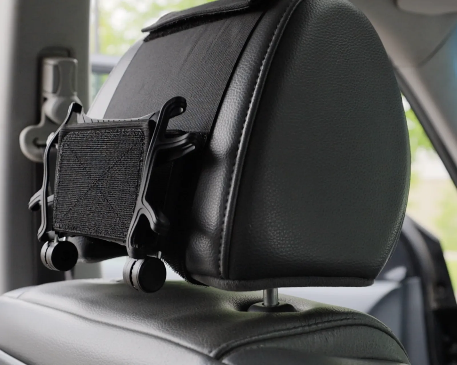 Tablet holder mounted on a car headrest