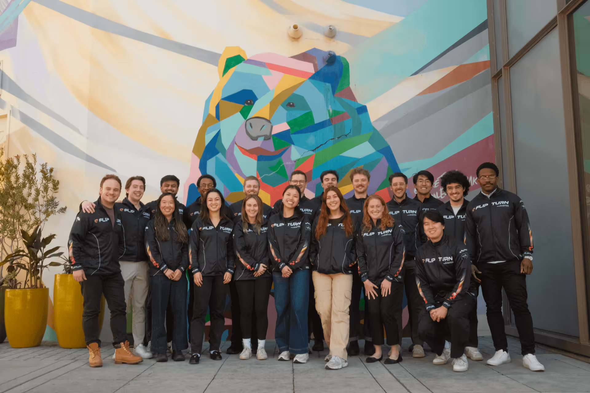 The Flipturn team wearing matching black company jackets