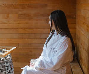 Woman wearing a robe in sauna