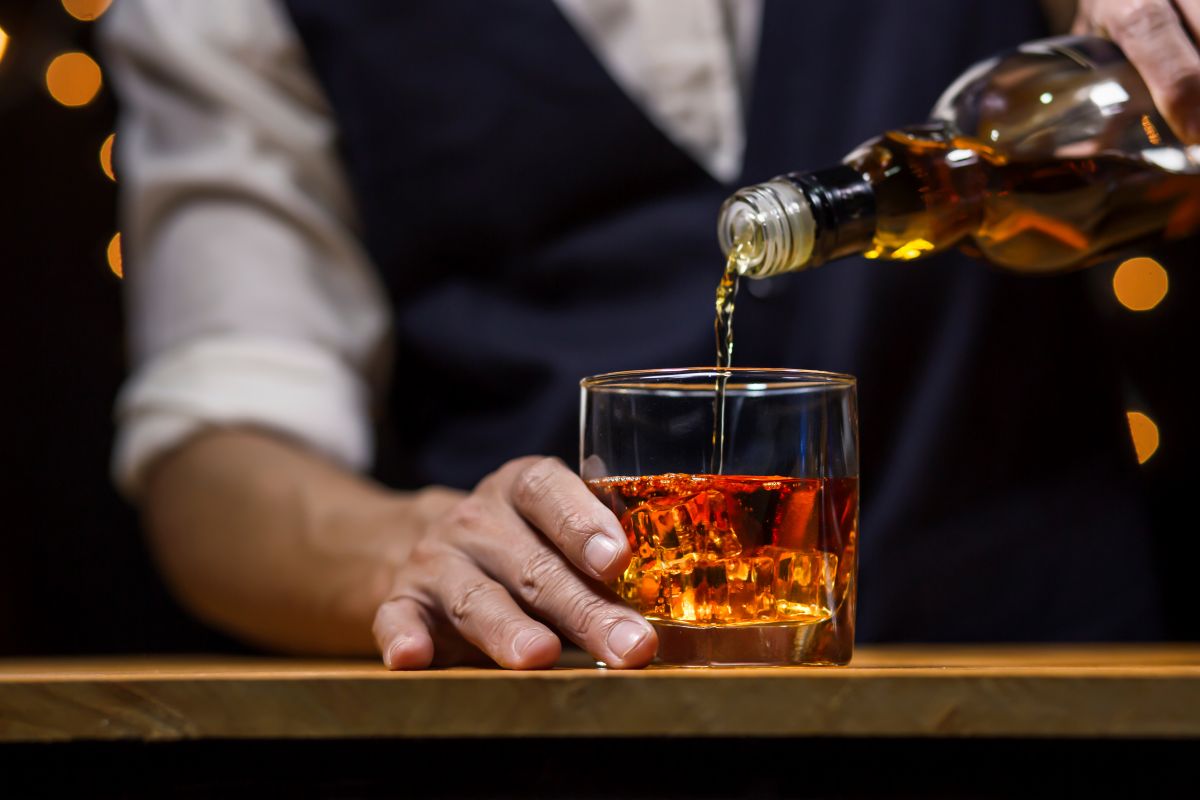 Bartender pouring a glass of whiskey