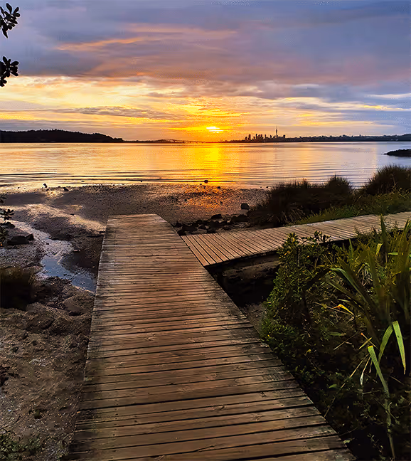 Image of Te Atatu walkway looking towards Auckland City at sunrise

