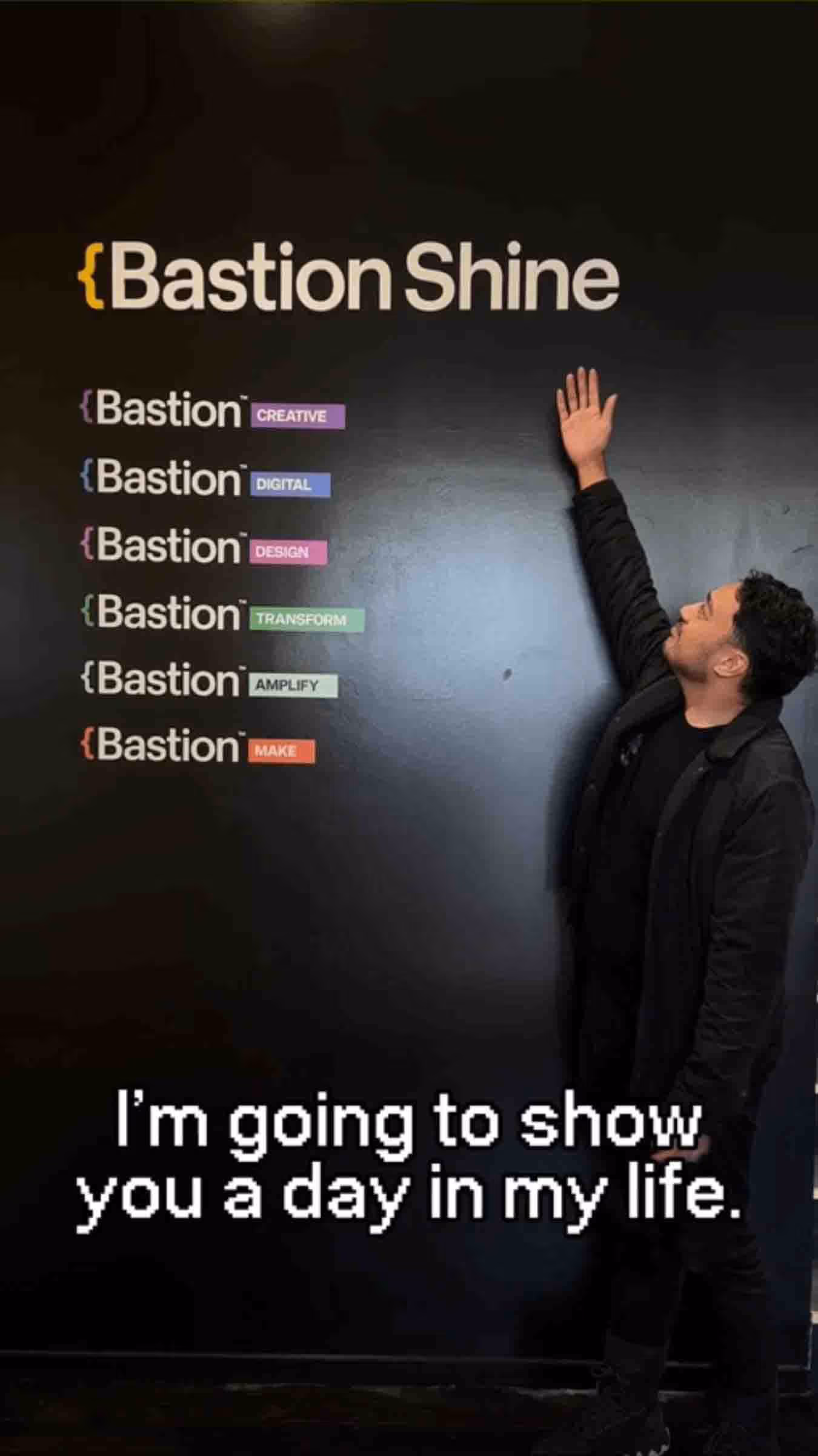 A man gestures toward a wall with the Bastion Shine logo and service list, with on-screen text that reads 'I'm going to show you a day in my life'.