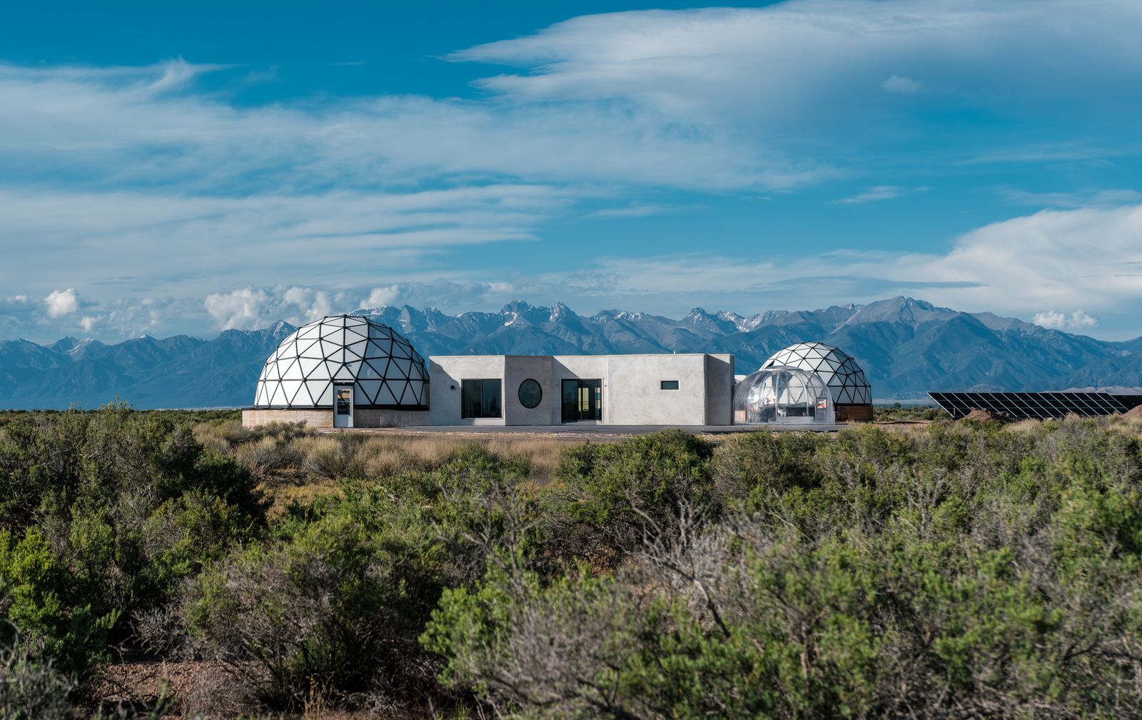 a luxury villa with white domes in a beautiful landscape
