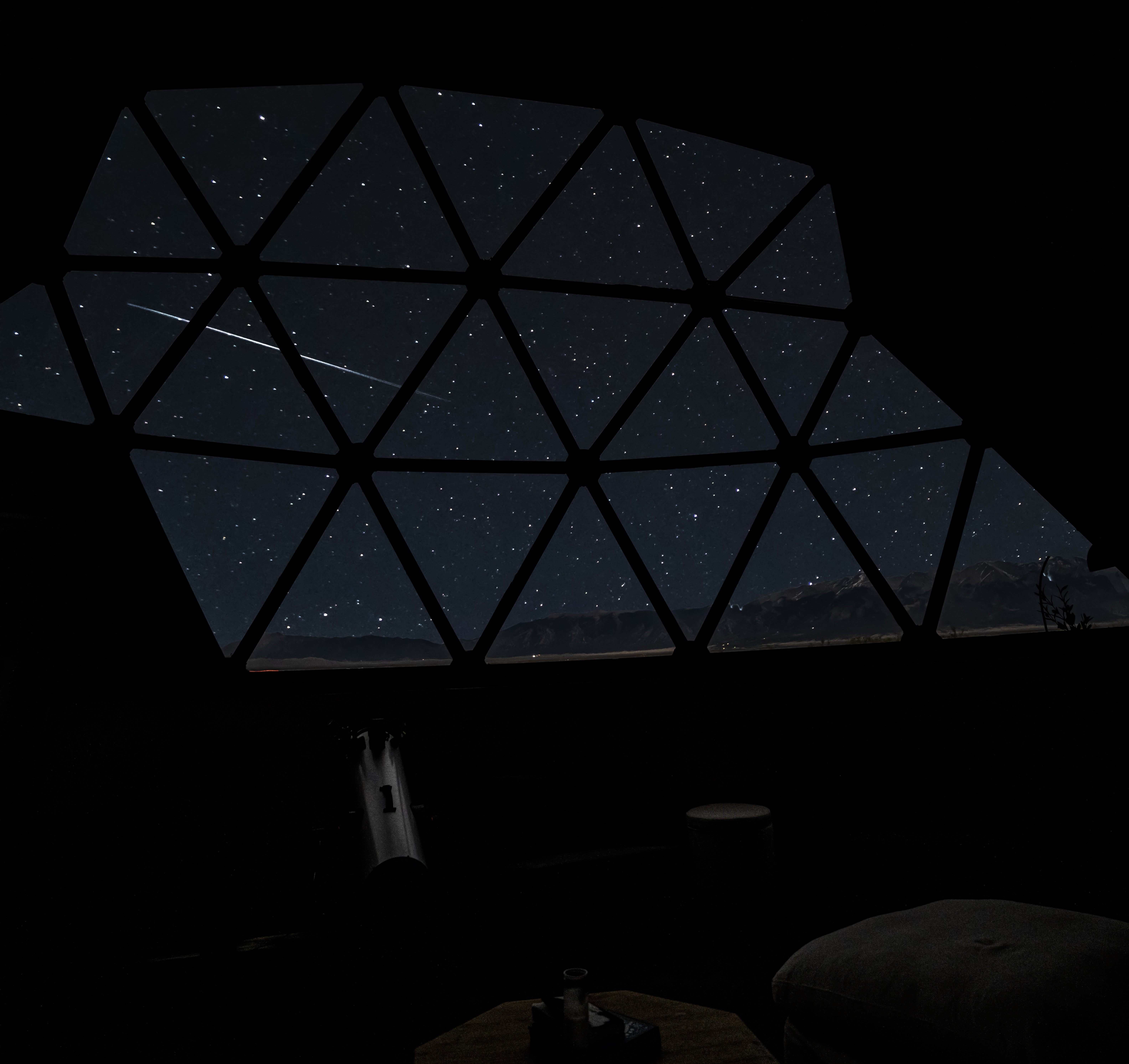A meteor seen through the dome window at Kosmos, photographed by Mark Cunningham