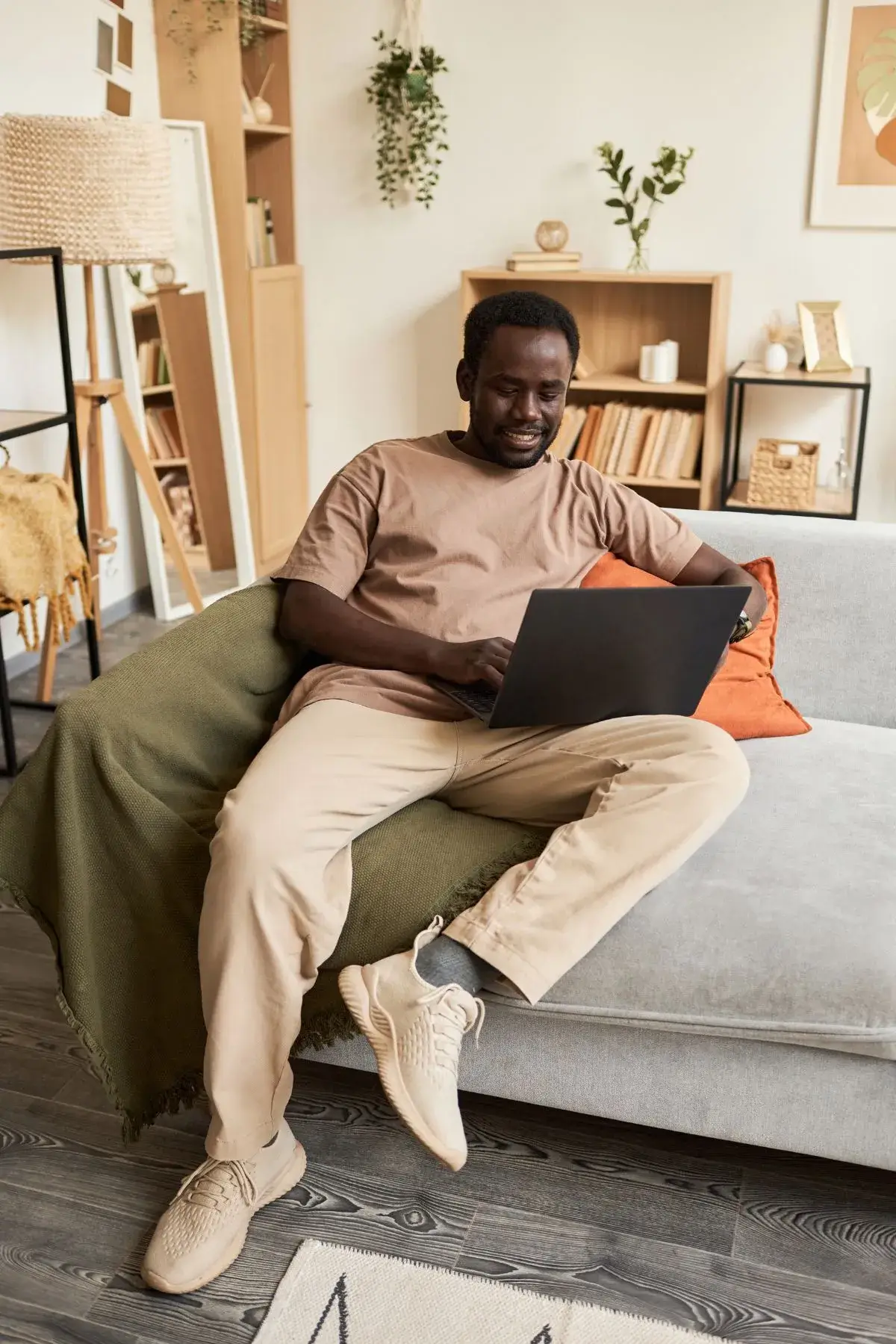 Man sitting on couch using a laptop