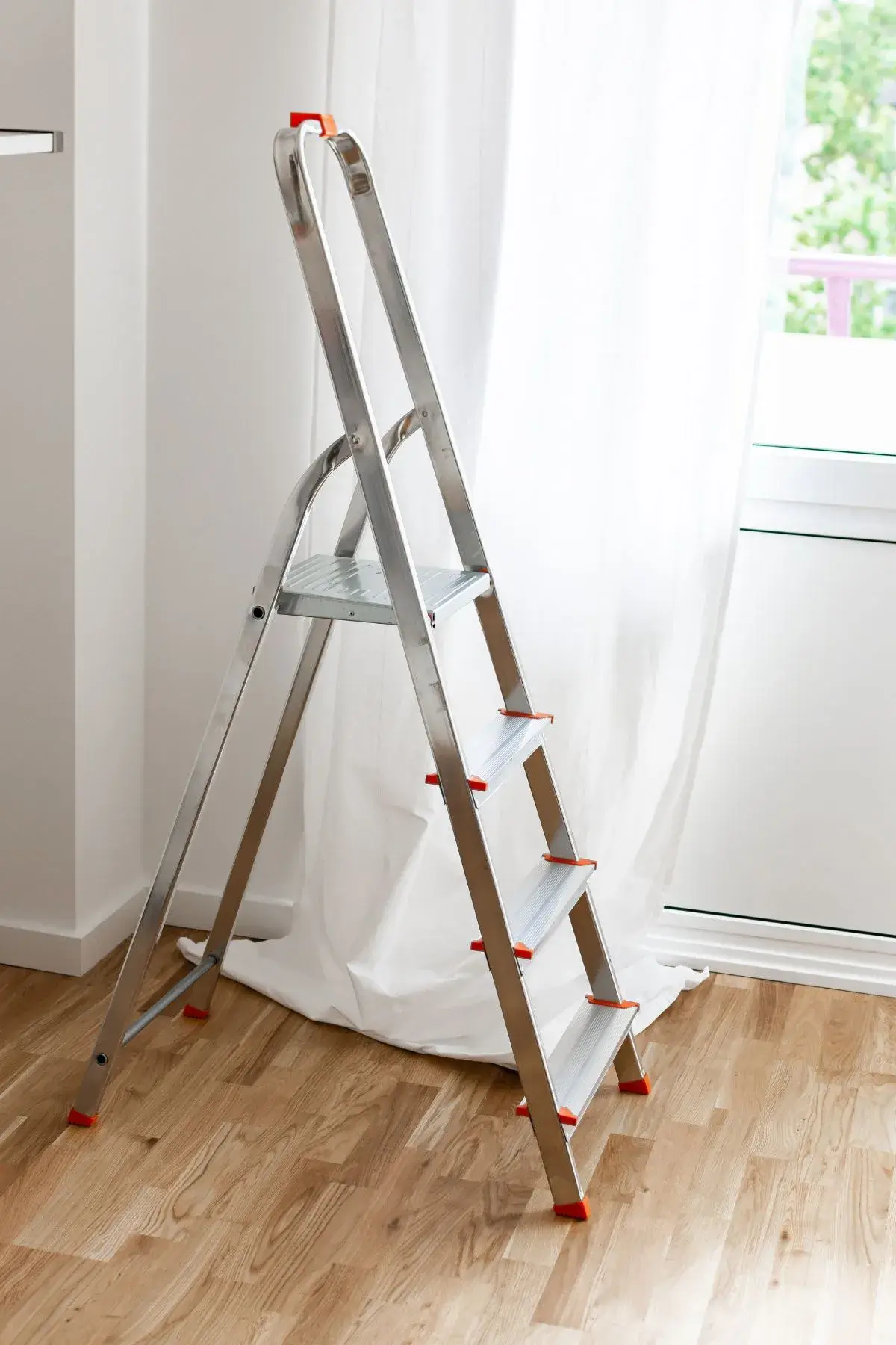 Step ladder inside a house next to a window