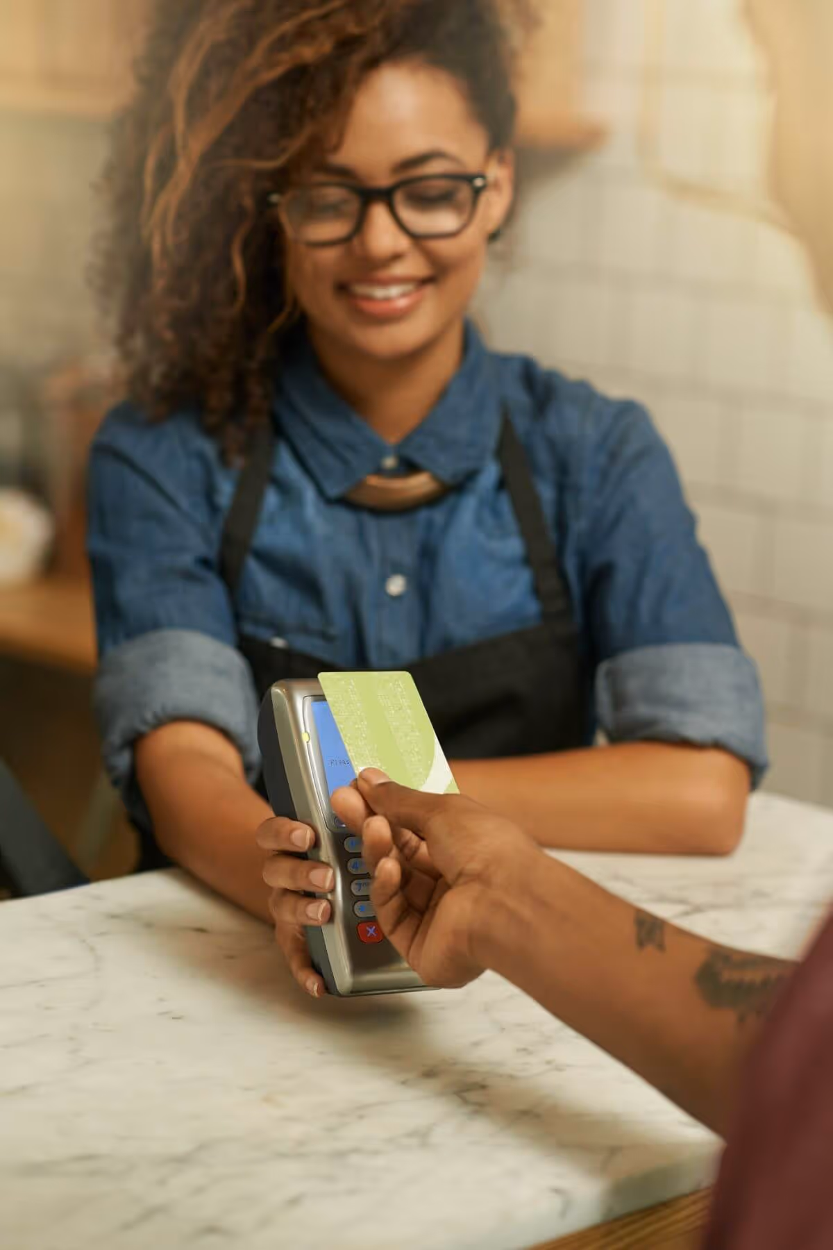 Woman accepting a tap card payment