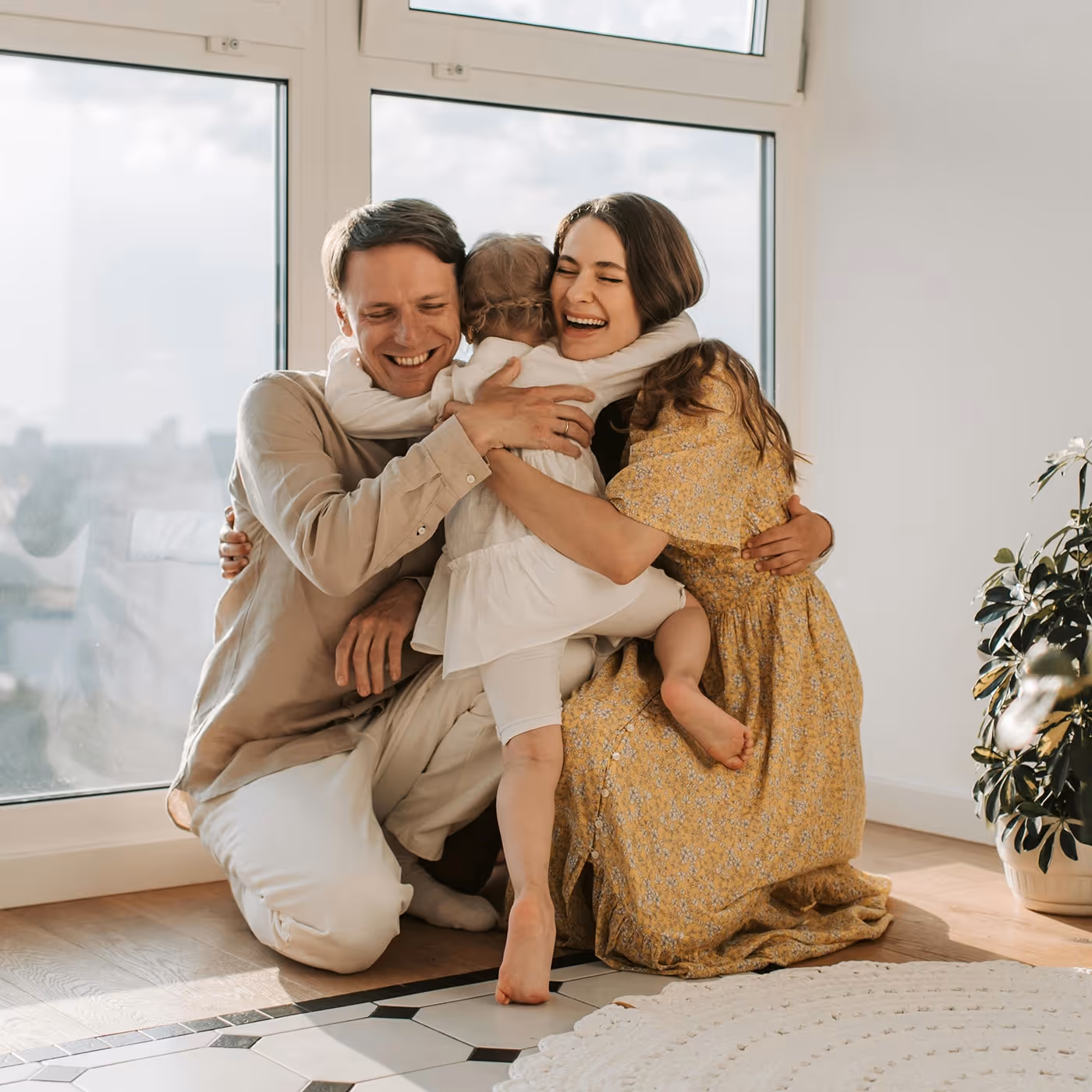 A couple hugging their child