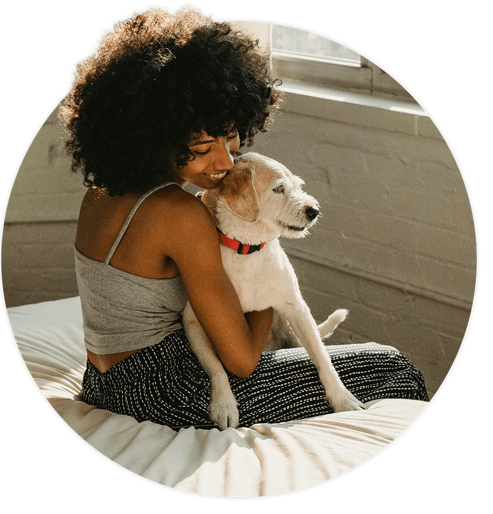 A young woman and her pet dog, relaxing in their apartment.