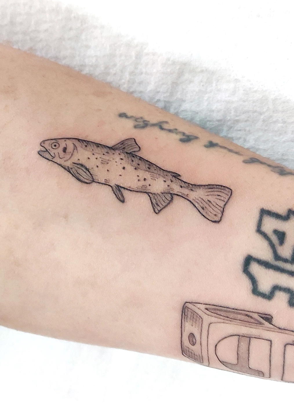 fine line bkinky tattoo