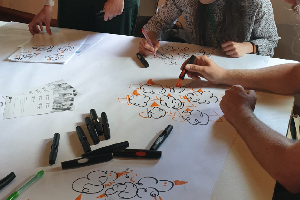 People drawing together in a workshop business drawing