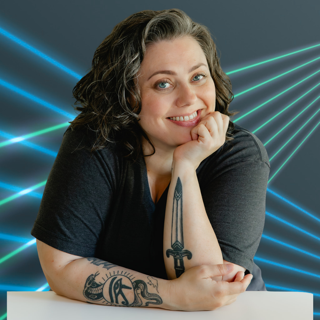 Sam of Spirituality with Sam laughing in front of a wall of green plants
