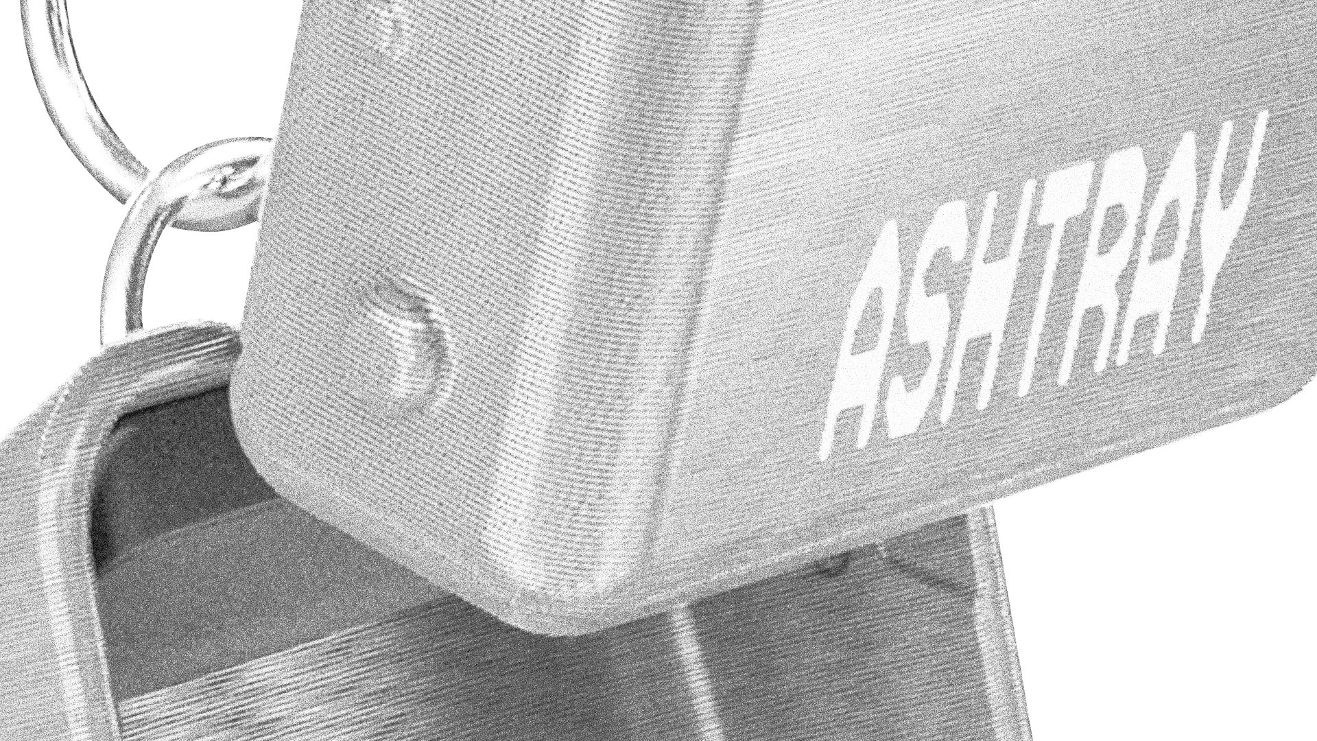 Large illuminated yellow advertisement with Ukrainian text displayed on a building, partially obscured by a leafless tree at night.