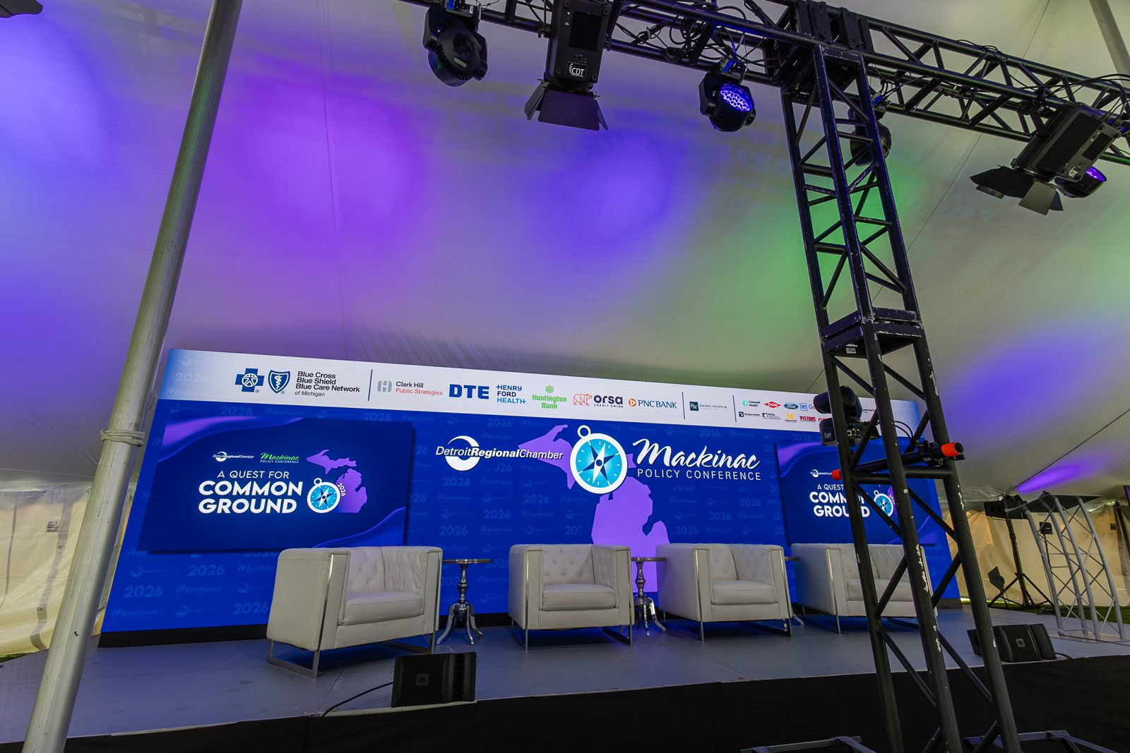 The Common Ground conference stage with lounge seating, an LED wall, and a lighting truss