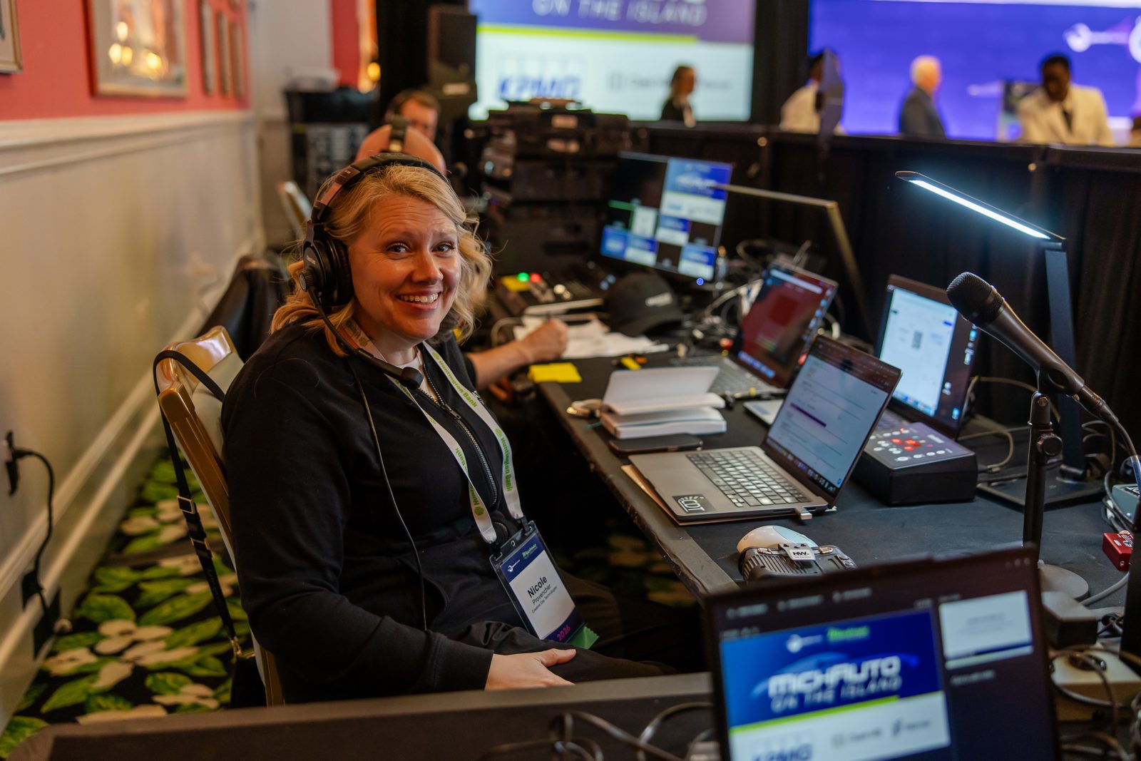 A Creative Day audio engineer smiling at a front-of-house control console