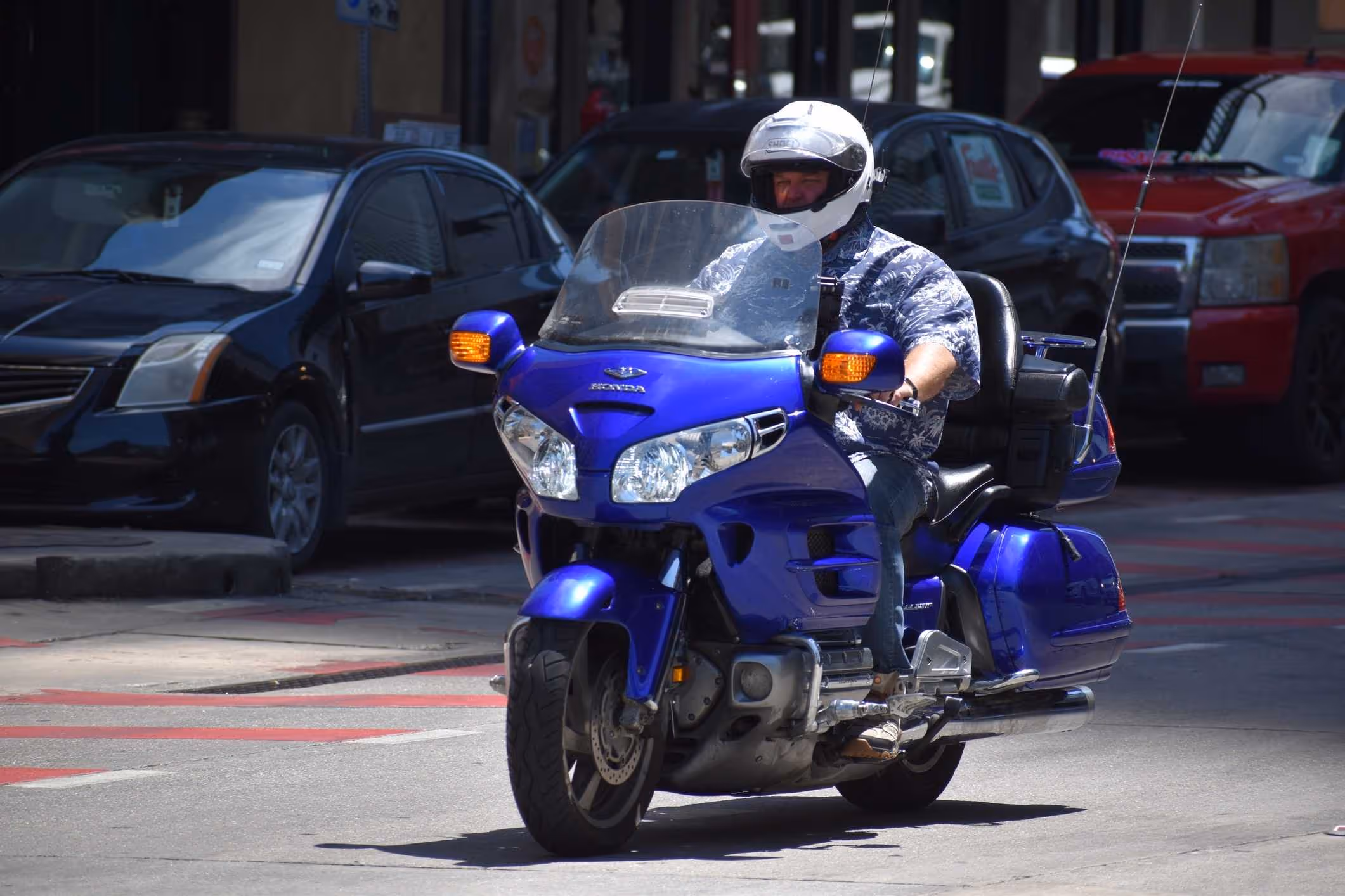 A motorcyclist riding a blue Honda Gold Wing, representing the services of a Williamsburg motorcycle accident lawyer.
