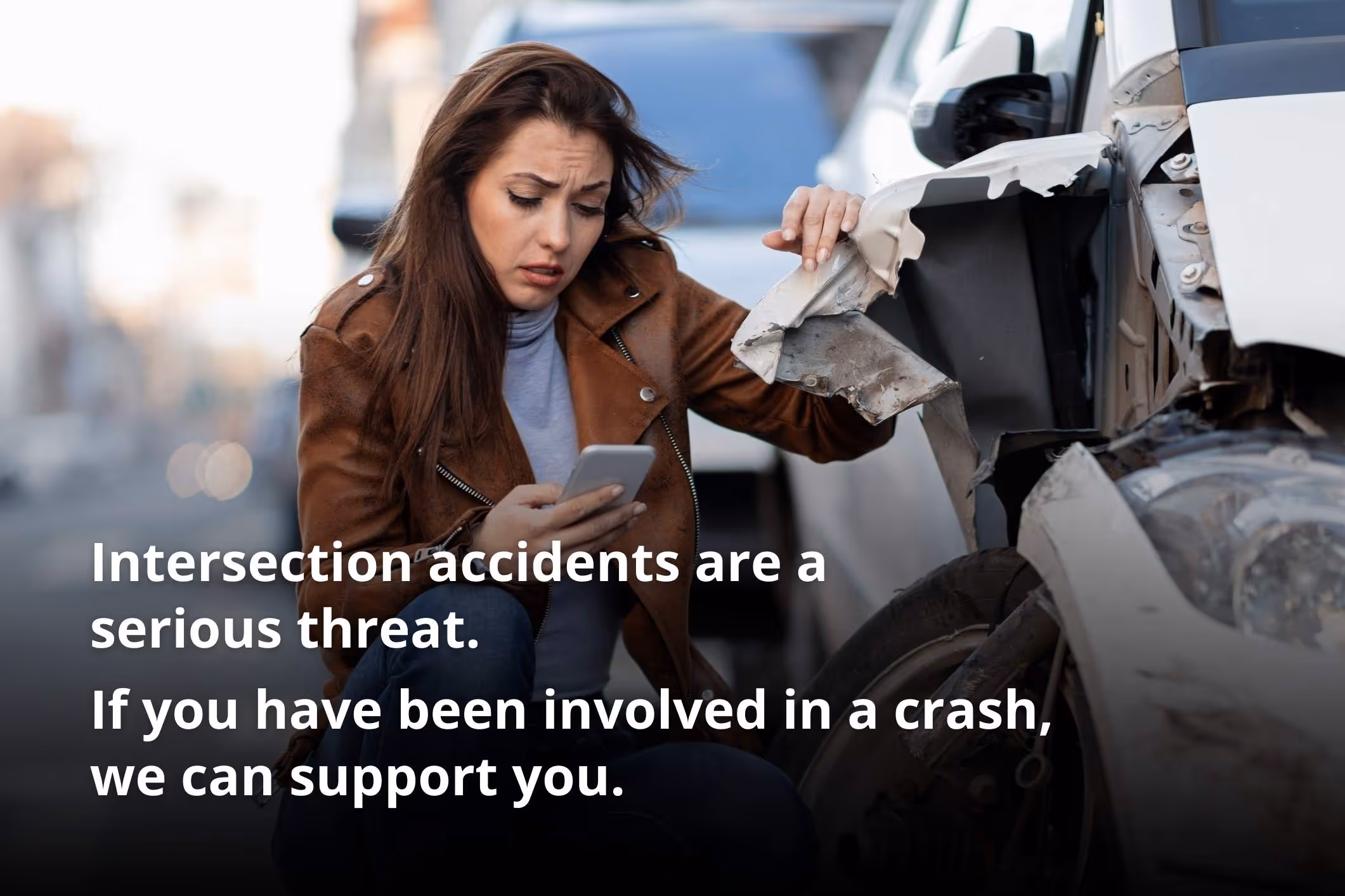 A woman calls for help after a distracted driver crashes into her. Distracted driving is a leading cause of intersection accidents.