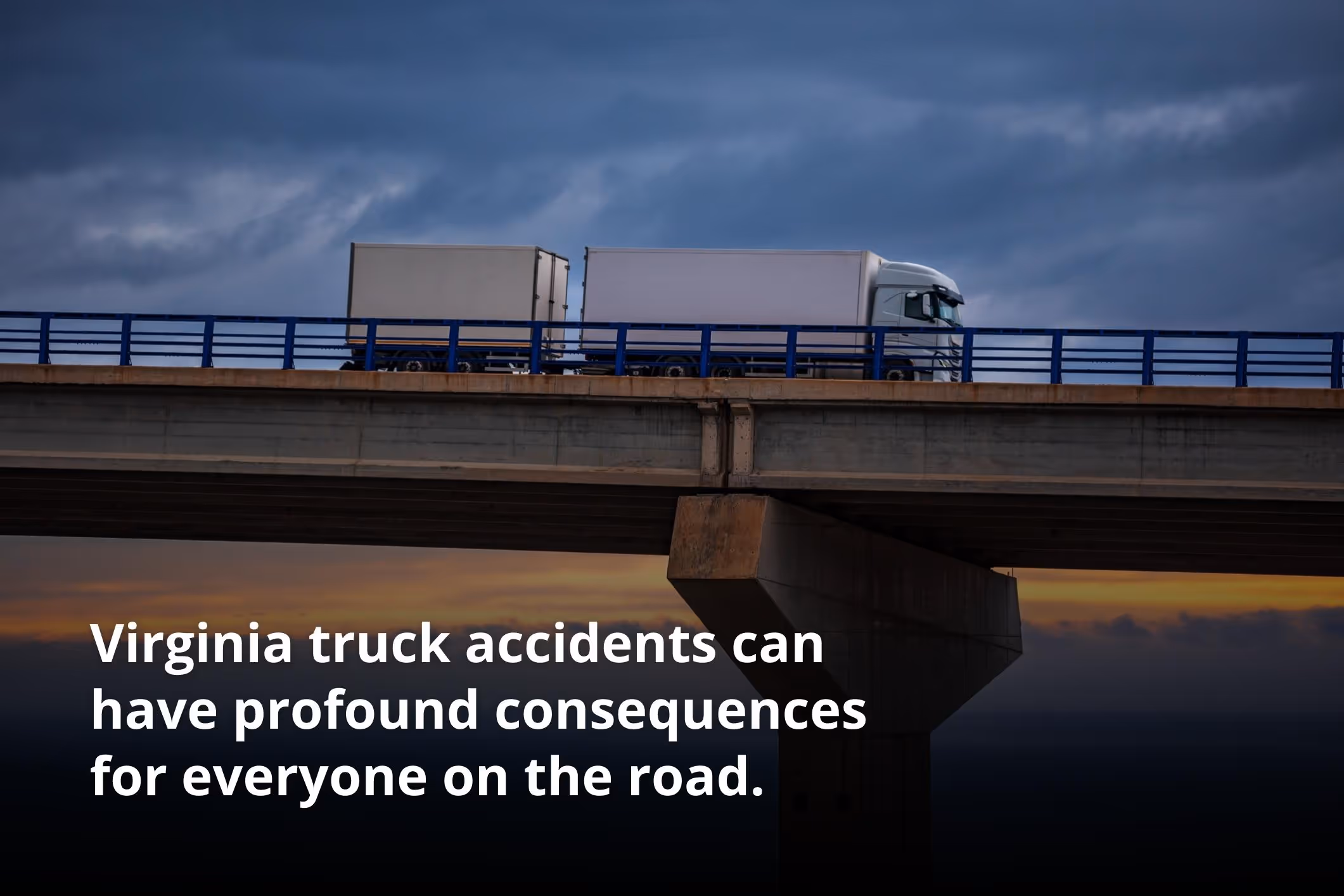 A semi-truck, one of the many that could contribute to Virginia truck accident statistics, crosses a bridge in front of a sunset horizon.