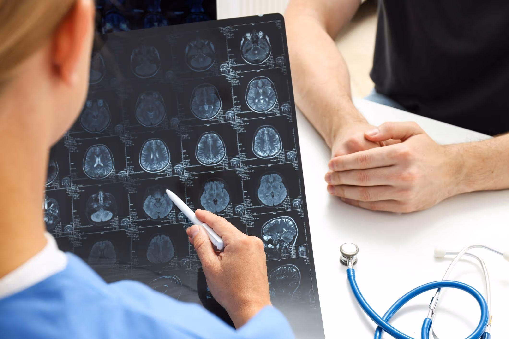Medical professional reviewing MRI of brain, representing claims guided by a Gloucester brain injury lawyer.