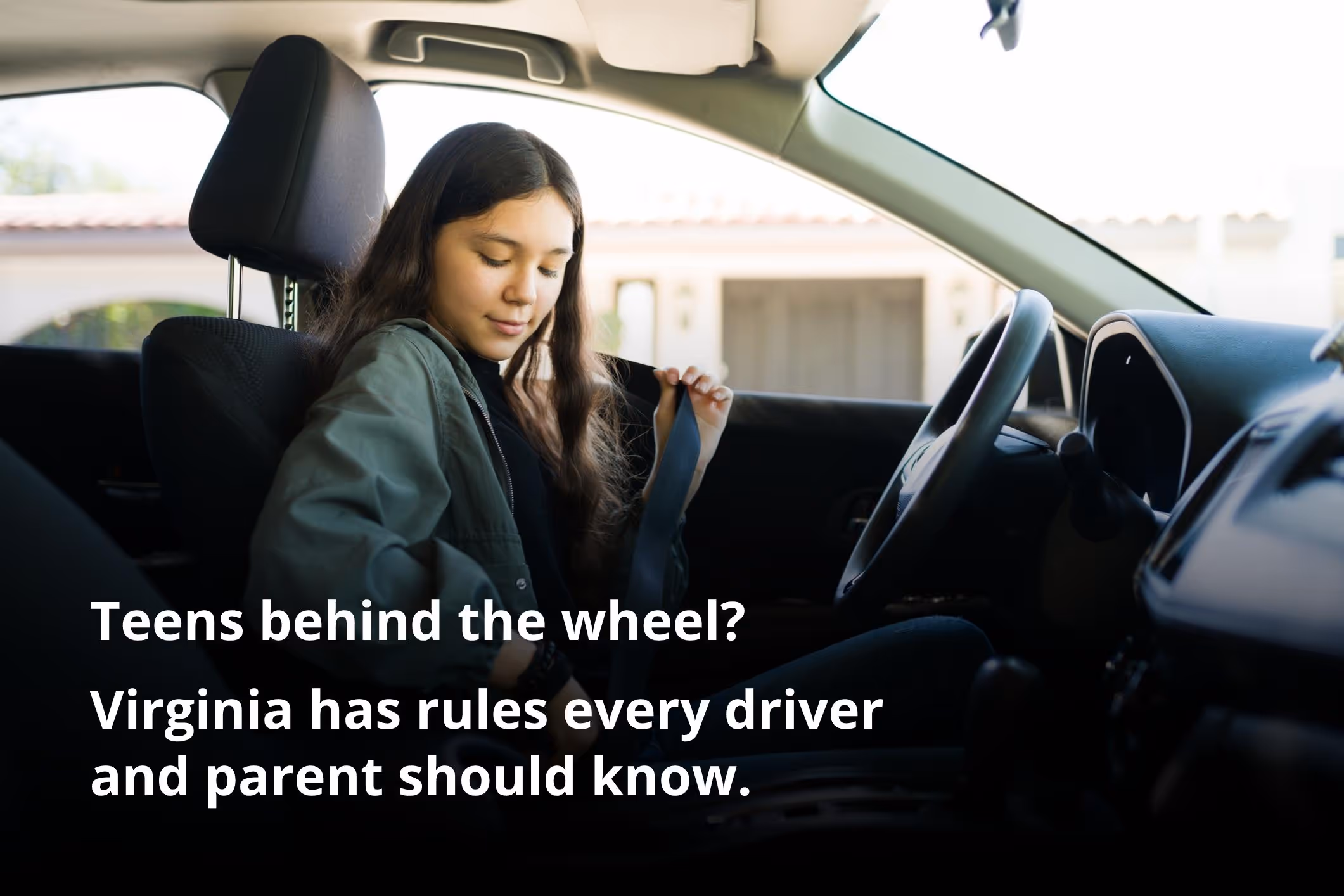 Adolescent girl behind the wheel of a car, representing a discussion about teenage driving laws in Virginia.