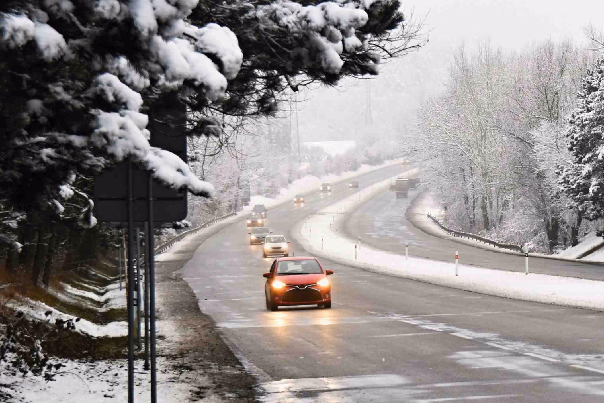 Cars on winter road with snow.