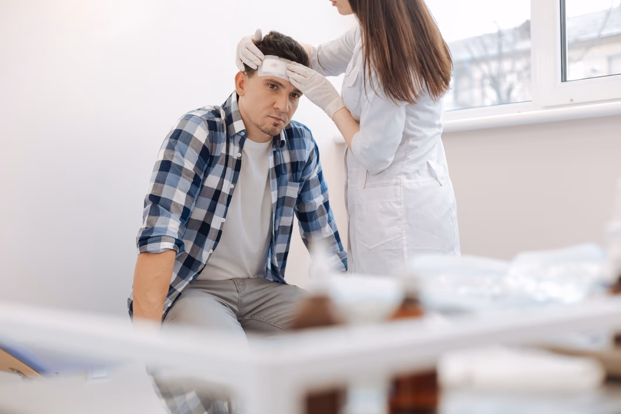 Unhappy sad man receiving the first aid.