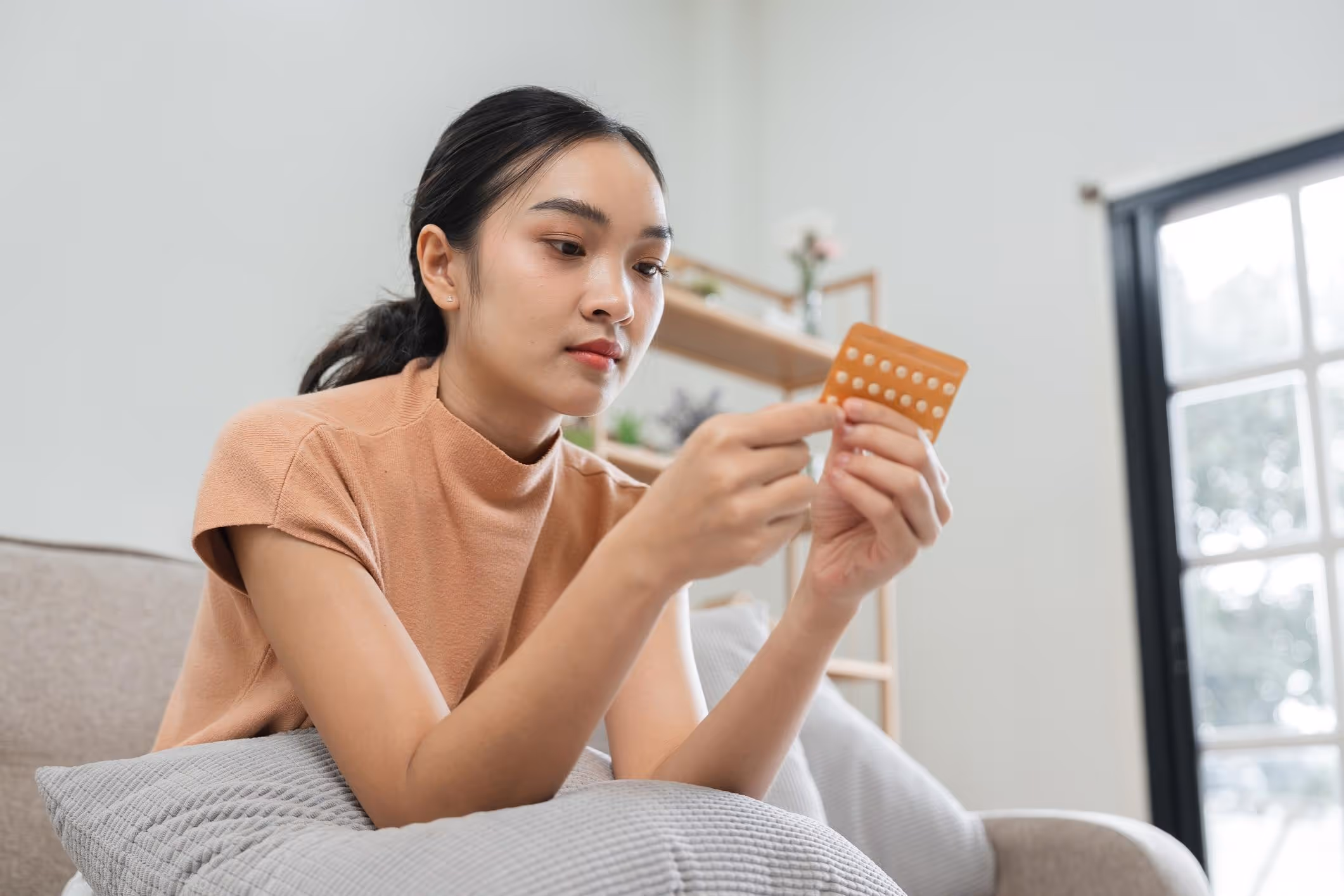 Woman Taking Birth Control Pills at Home.