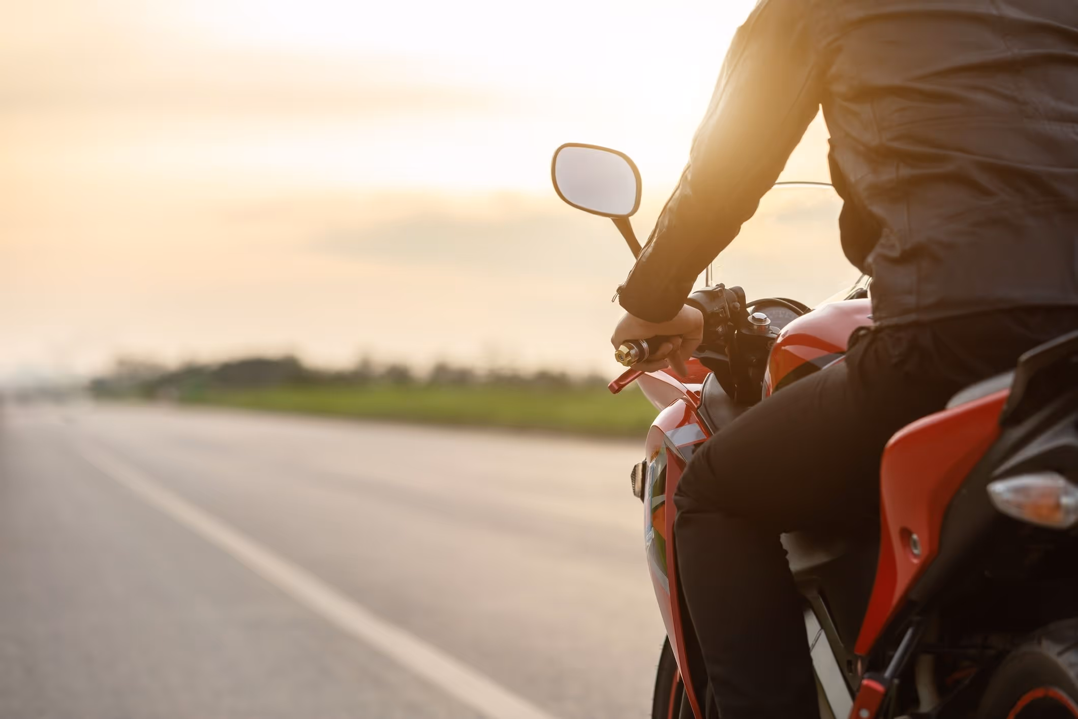 Rear View Of Man Riding Motorcycle On Road.
