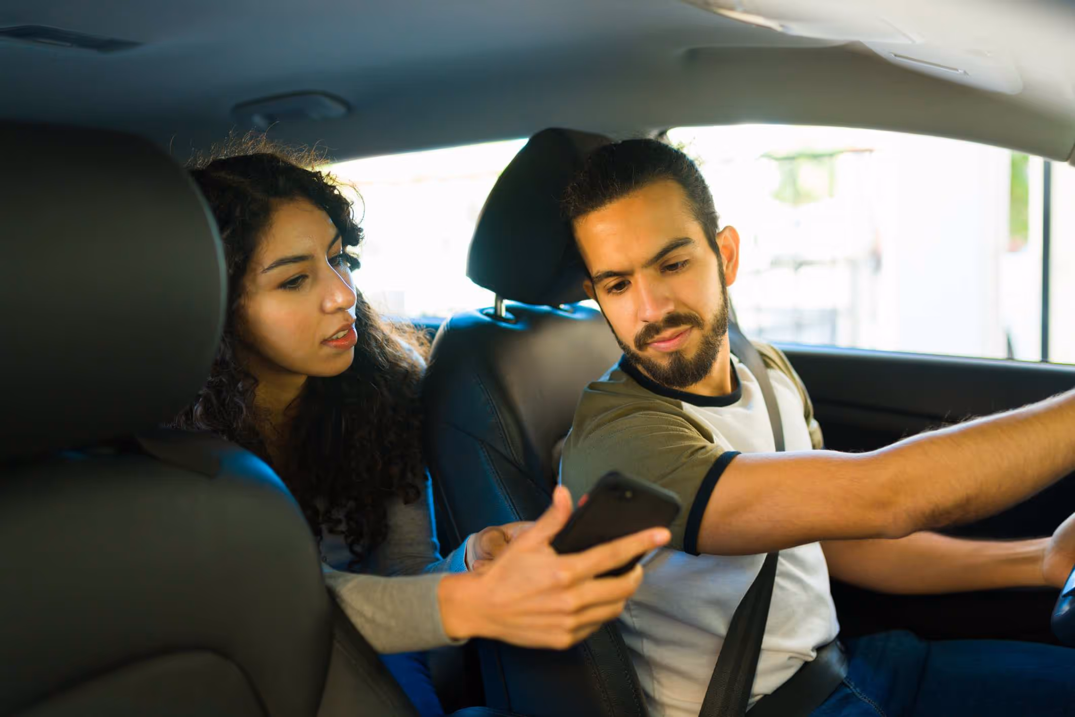 A driver reviewing the Uber driver insurance claim policy.