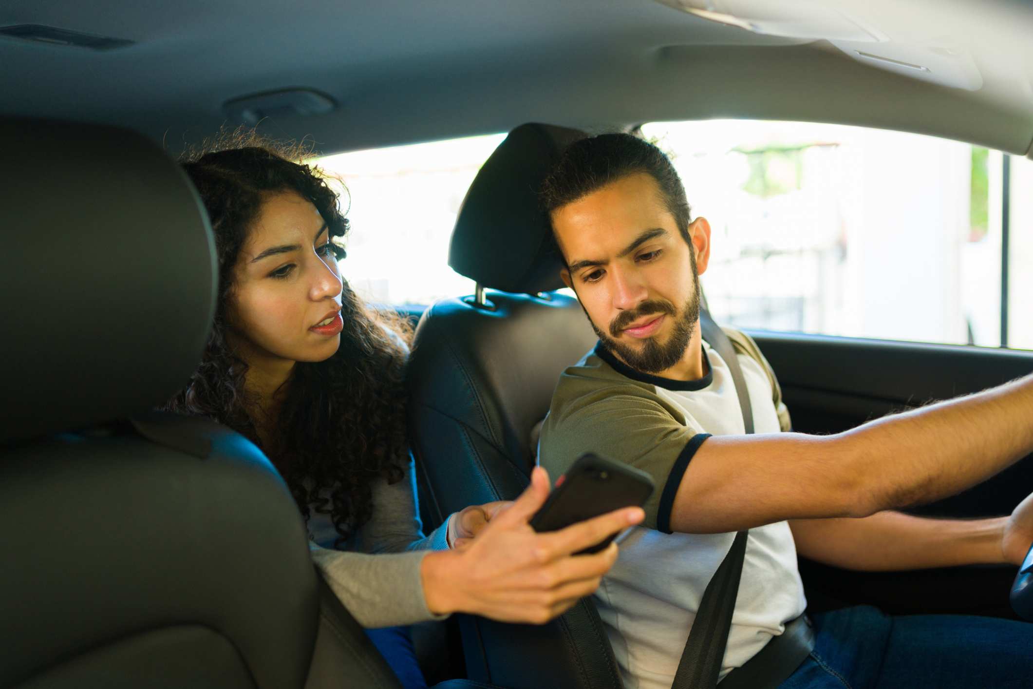 A driver reviewing the Uber driver insurance claim policy.