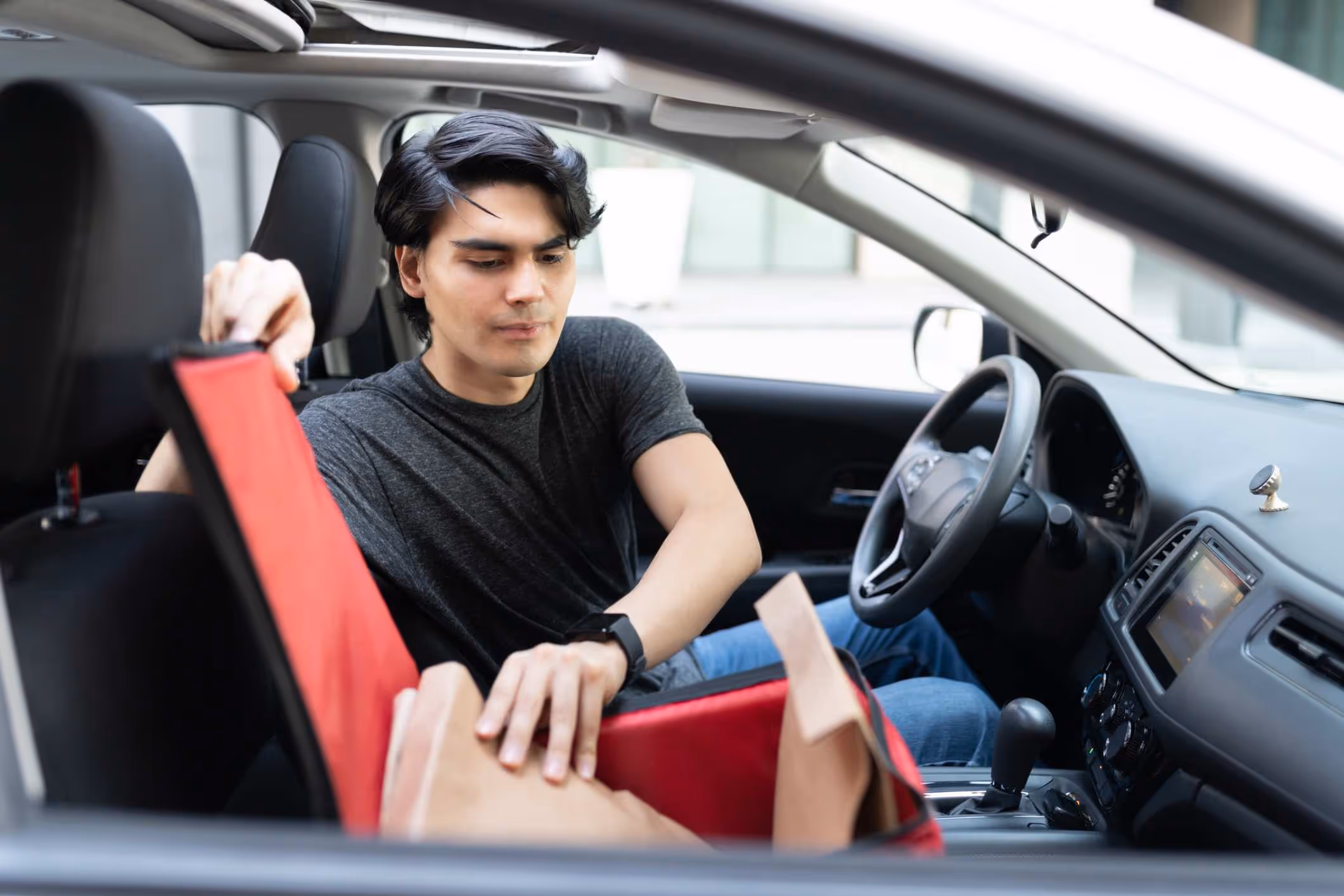 A driver out delivering after filing a successful DoorDash driver car accident claim.