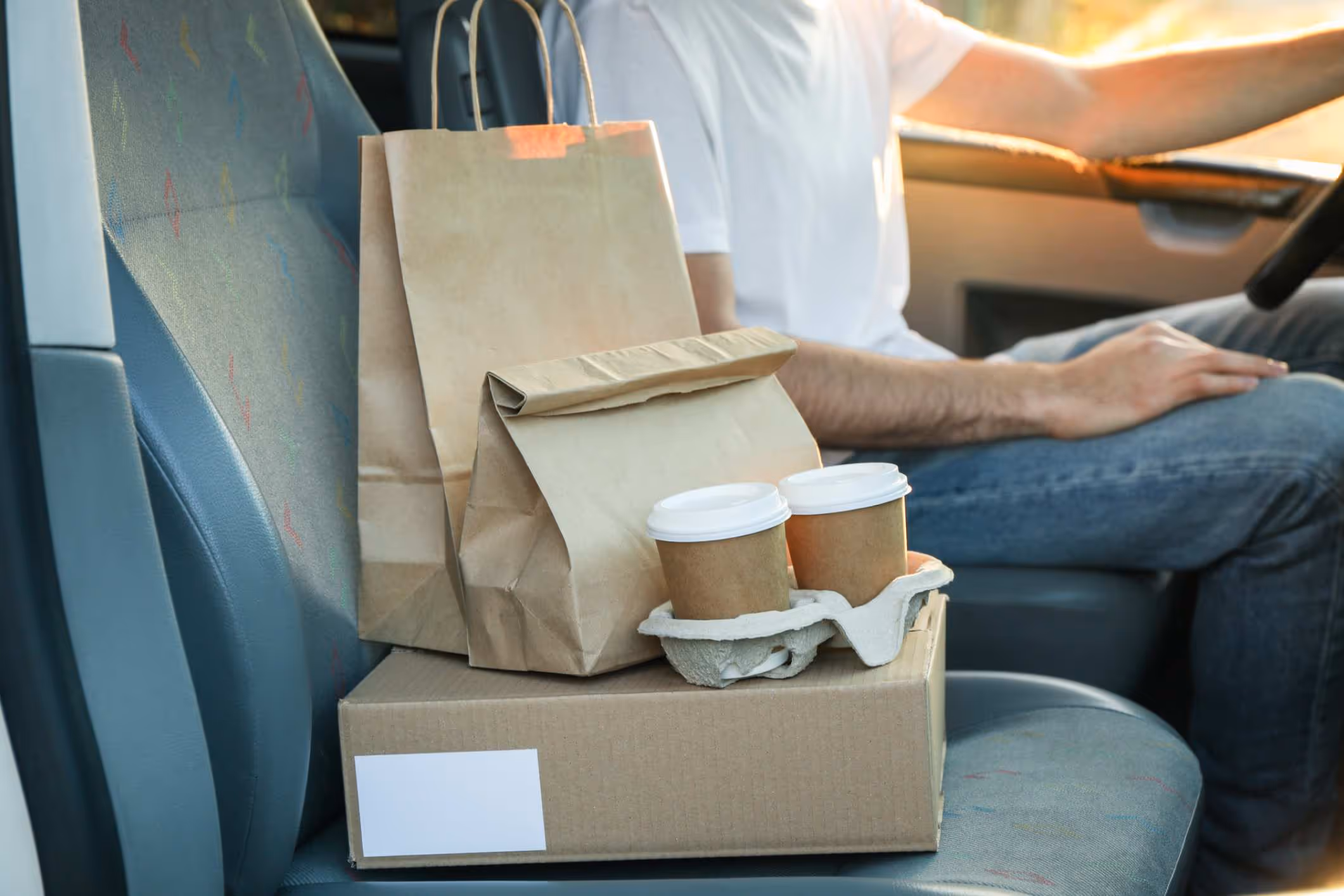 A driver delivering food after a lawyer helped them with Grubhub insurance claims. 