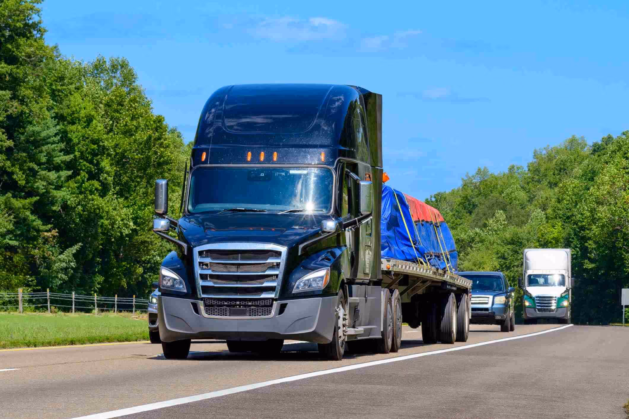 Flatbed semi on highway, representing cases handled by a Virginia Beach truck accident lawyer.