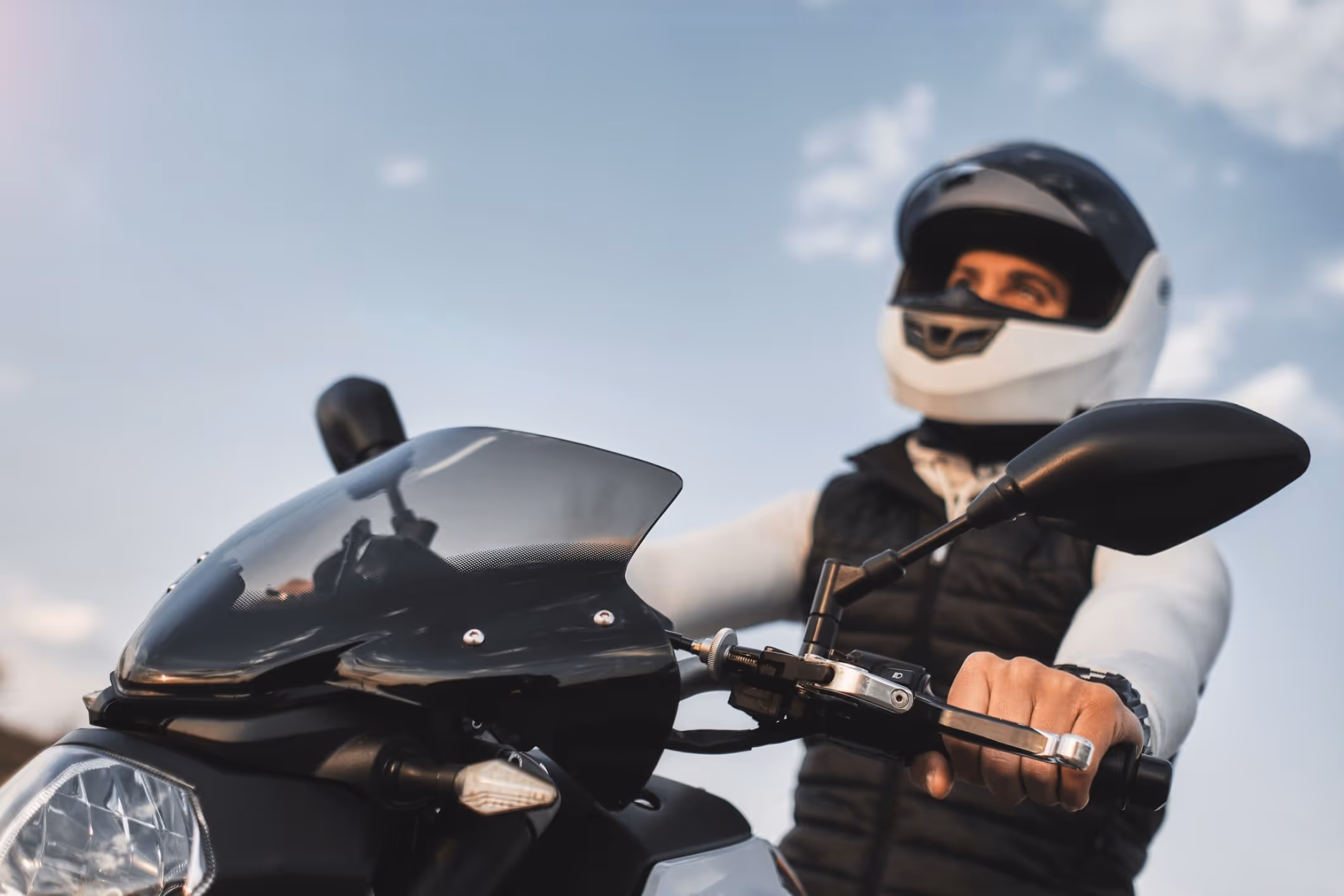 Motorcyclist wearing helmet on bike, representing Chesapeake motorcycle accident lawyer cases.