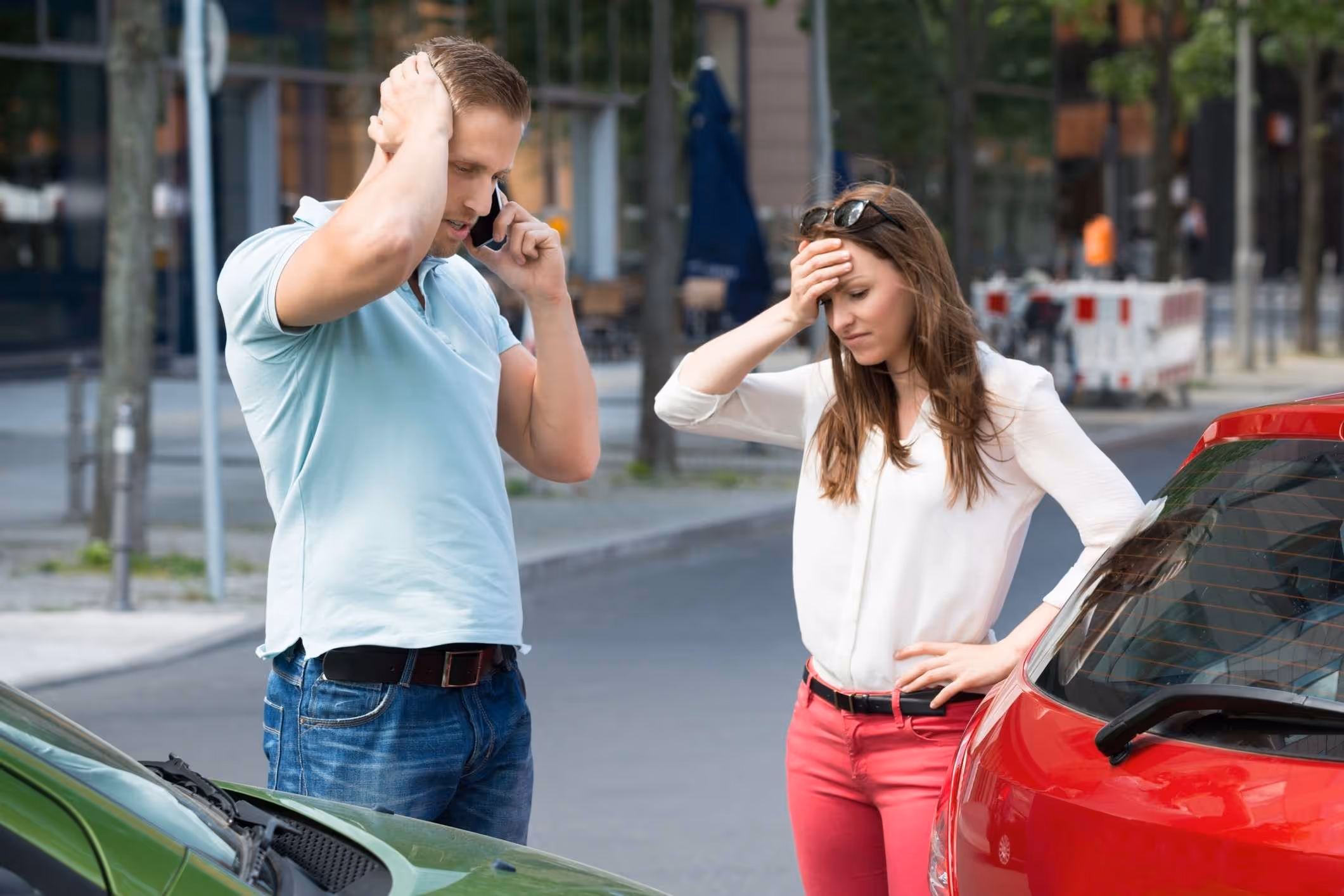 Man on phone after car collision, representing Chesapeake car accident lawyer injury claims.