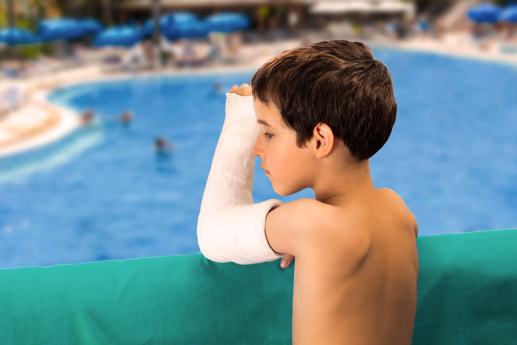 Sad boy after swimming pool accident and injury.