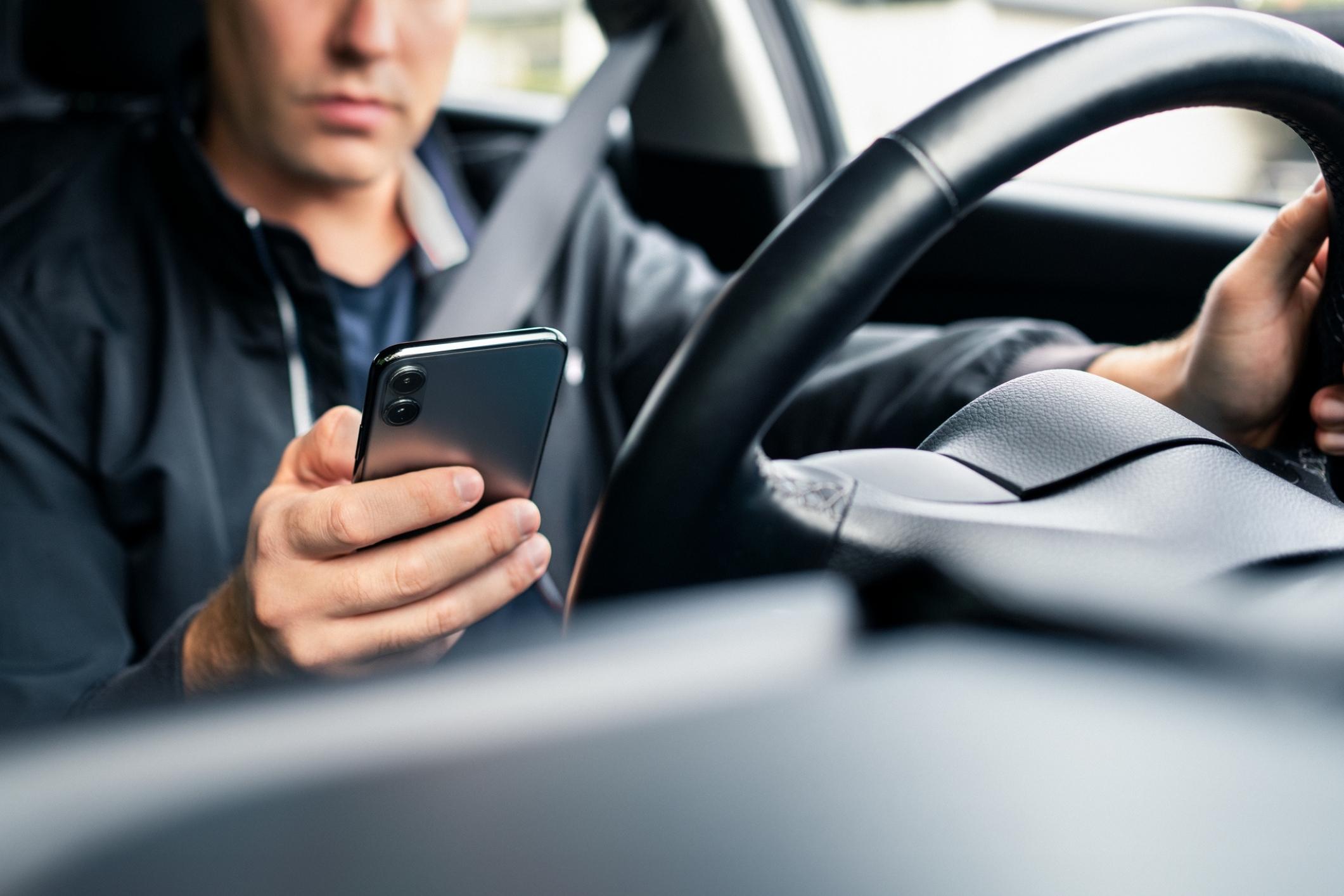 Driver of Uber is on his phone, which can lead to car accident.