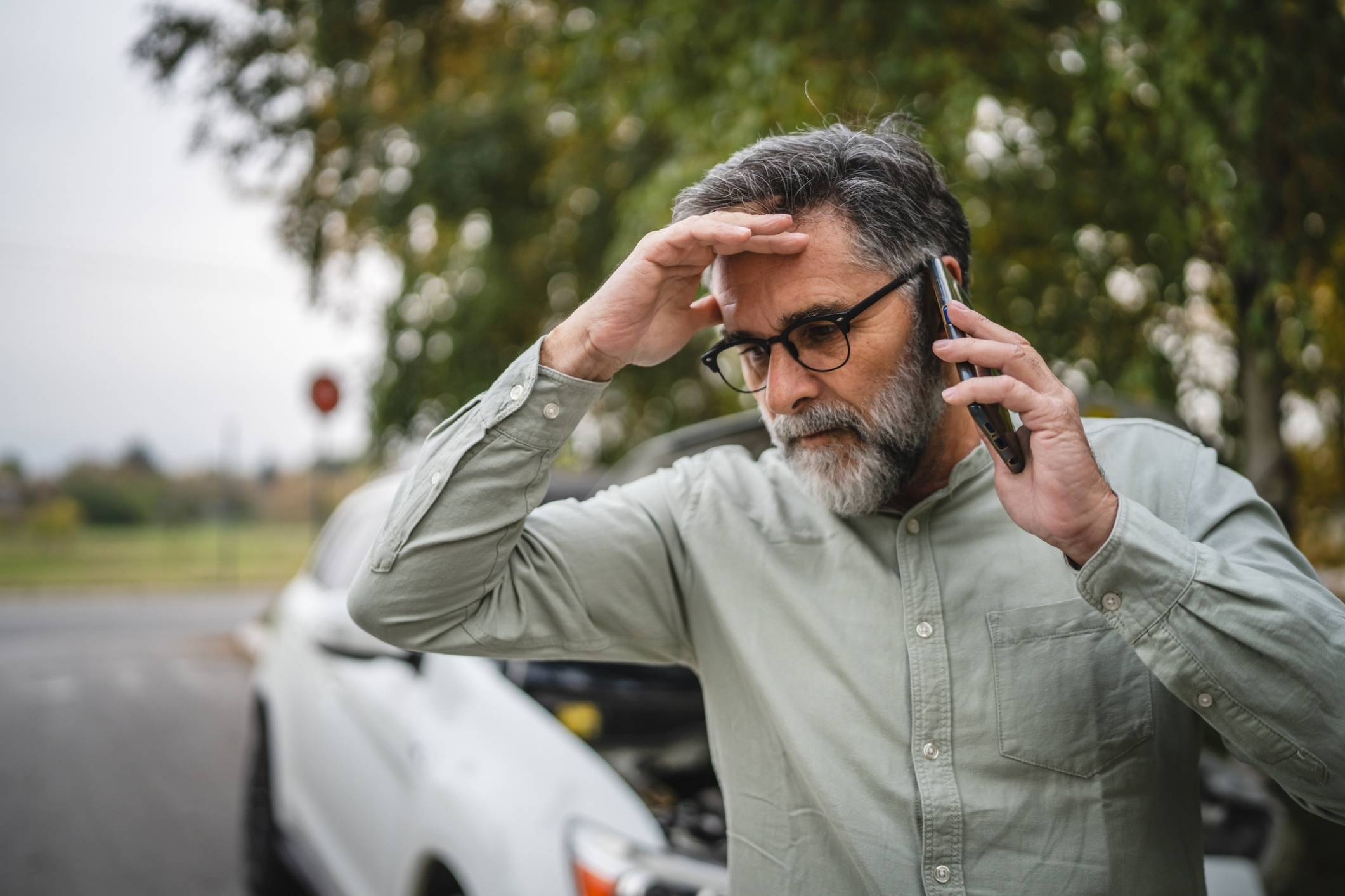 Man is ignoring his symptoms after a car accident.