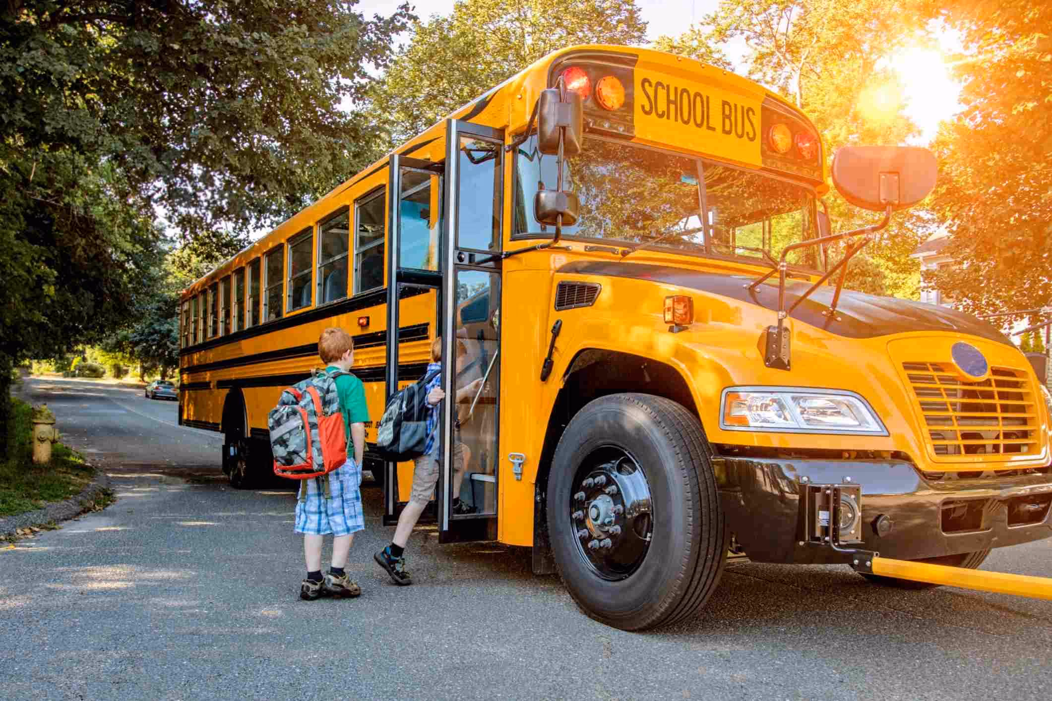 Young boy boarding school bus, representing Virginia school bus accident lawyer cases.