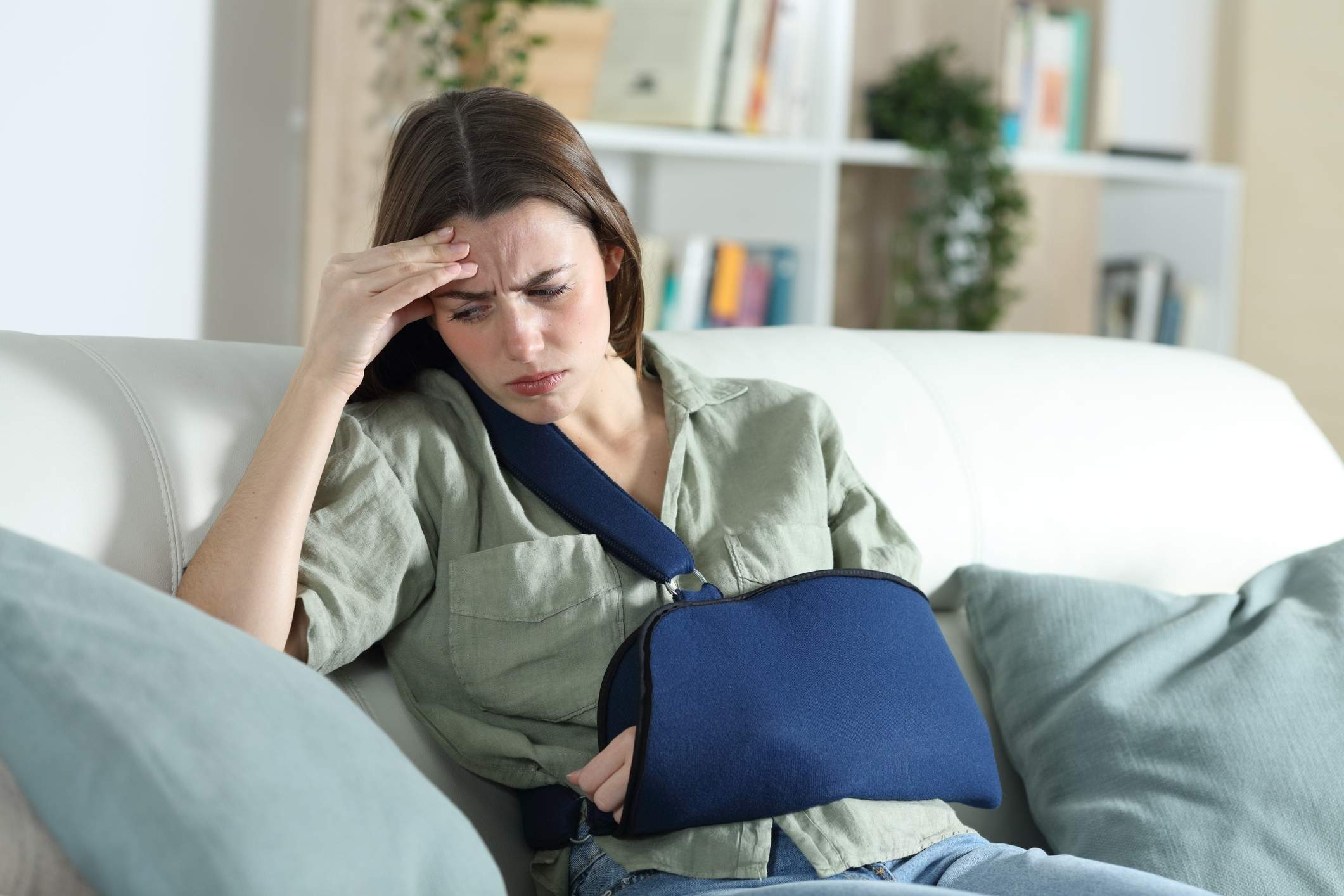 Injured woman with her arm in a sling considers contacting a Richmond personal injury lawyer.