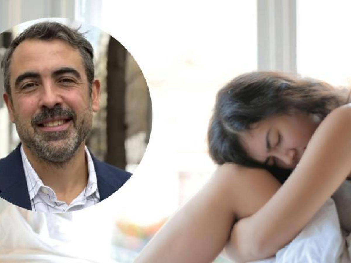 Woman sitting with knees pulled in and head resting on them, with an inset portrait of a man.