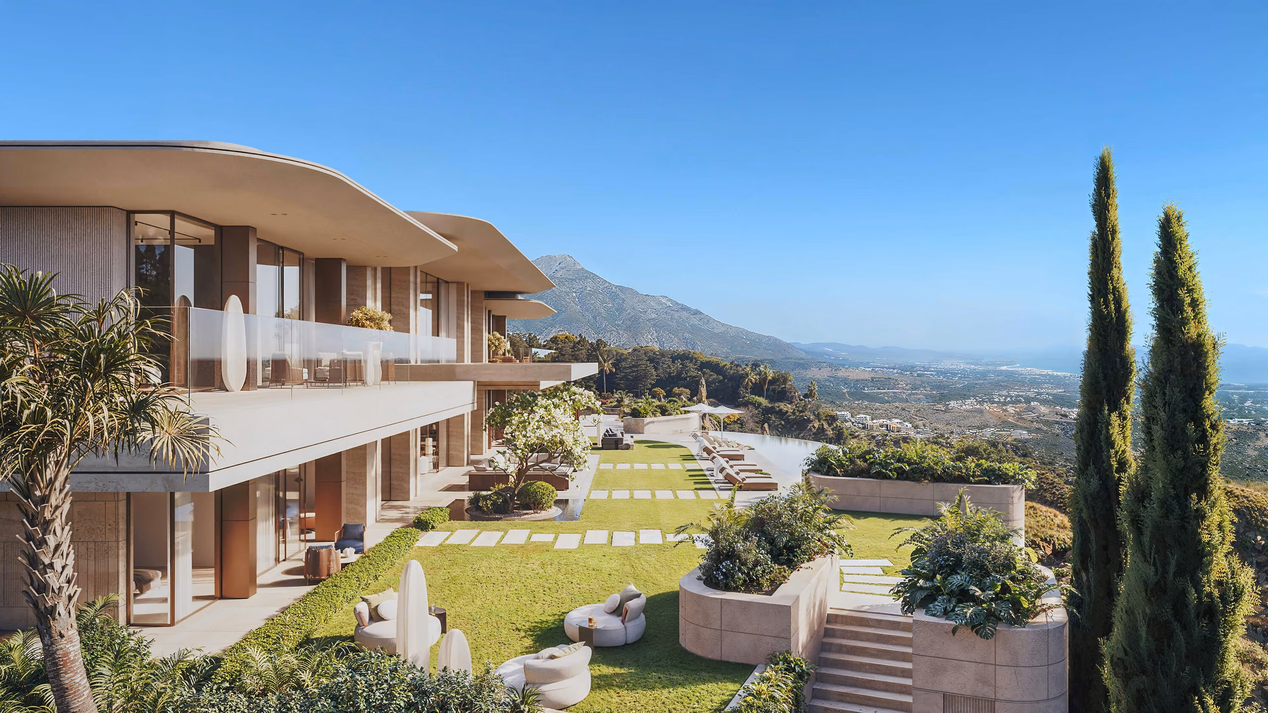Planted terraces with glass balconies and views towards the mountains and coast.