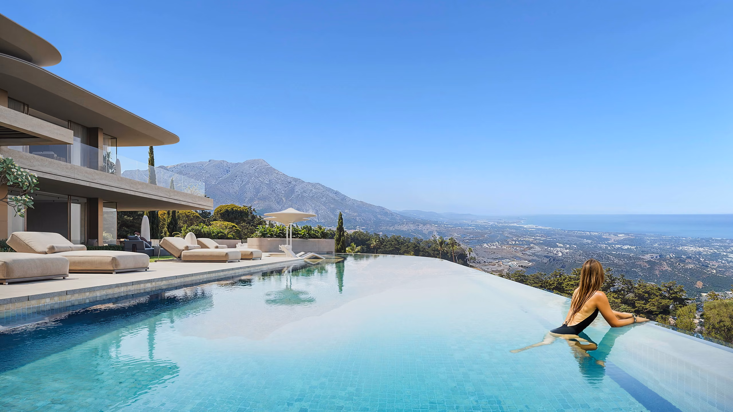 Infinity pool beside the villa terrace with mountain and coastal views — La Zagaleta