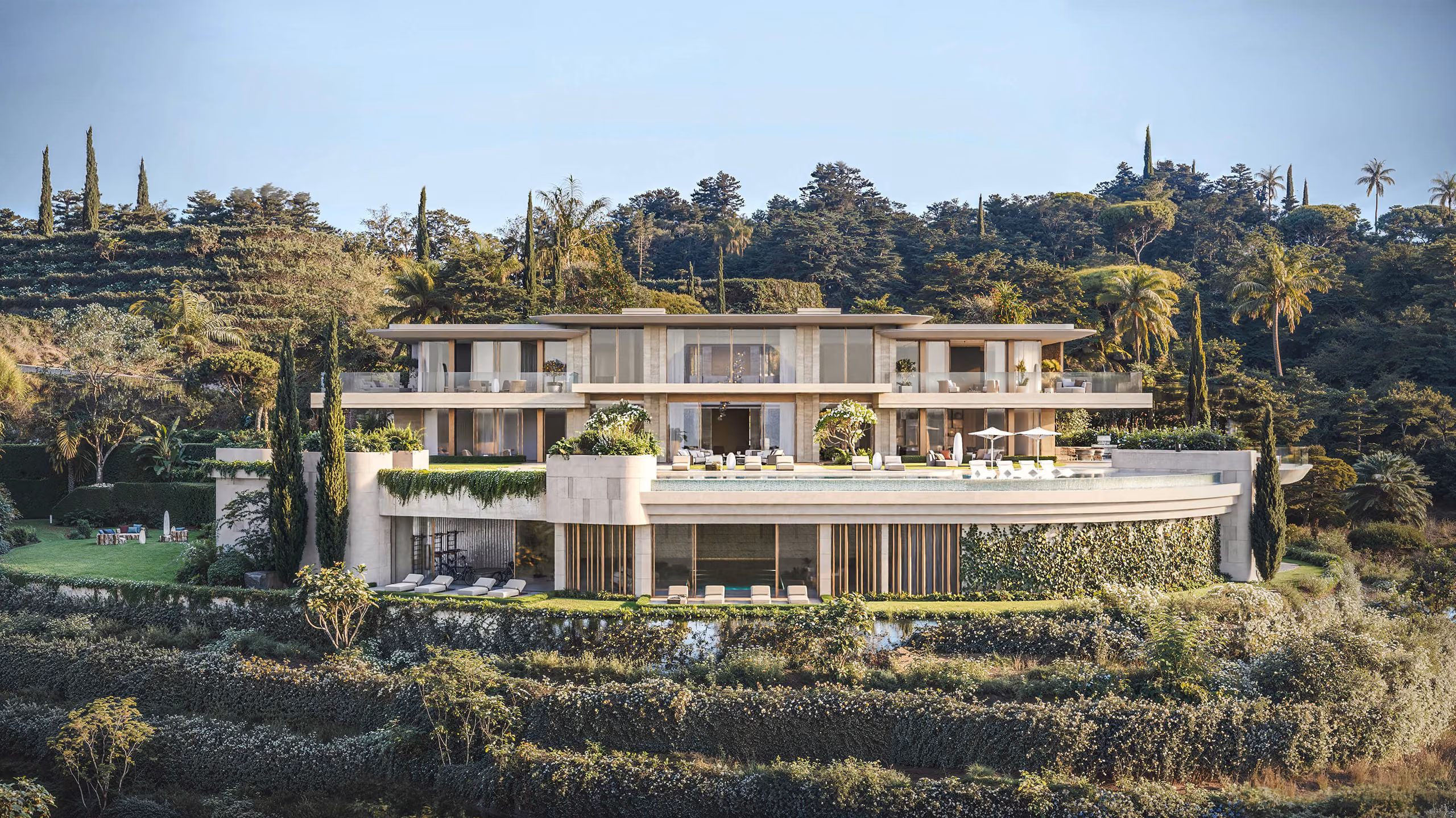 Horizontal villa façade with pale stone, glazing and planted terraces — La Zagaleta