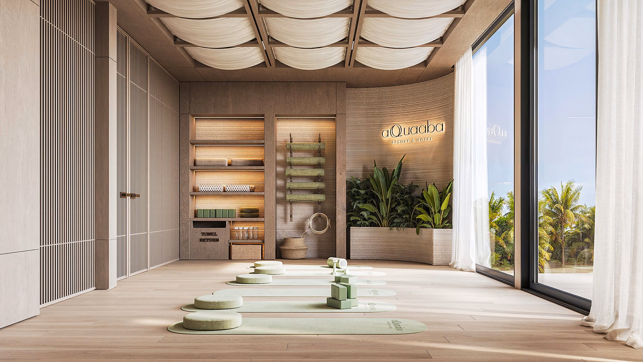 Aqquaaba yoga room with green mats, cushions and shelving beneath light-colored ceiling panels.