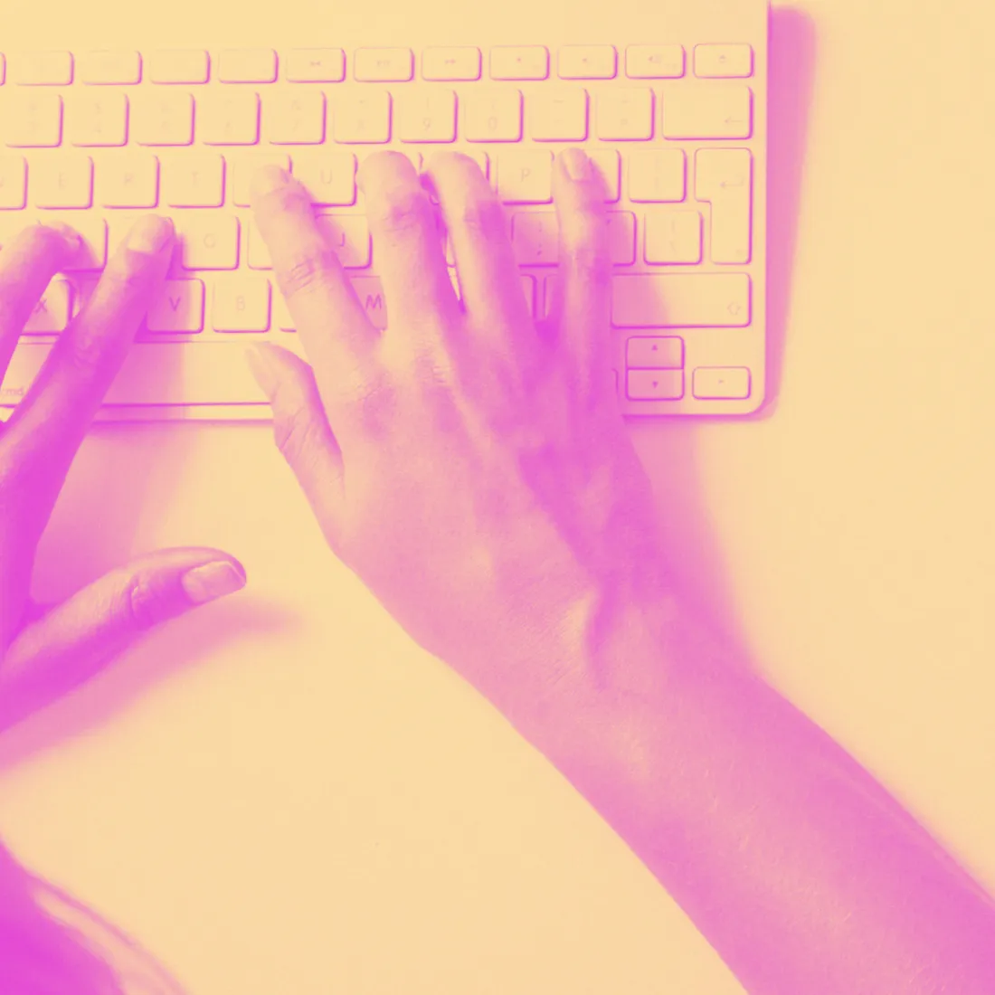 image with duotone effect of a person typing on keyboard