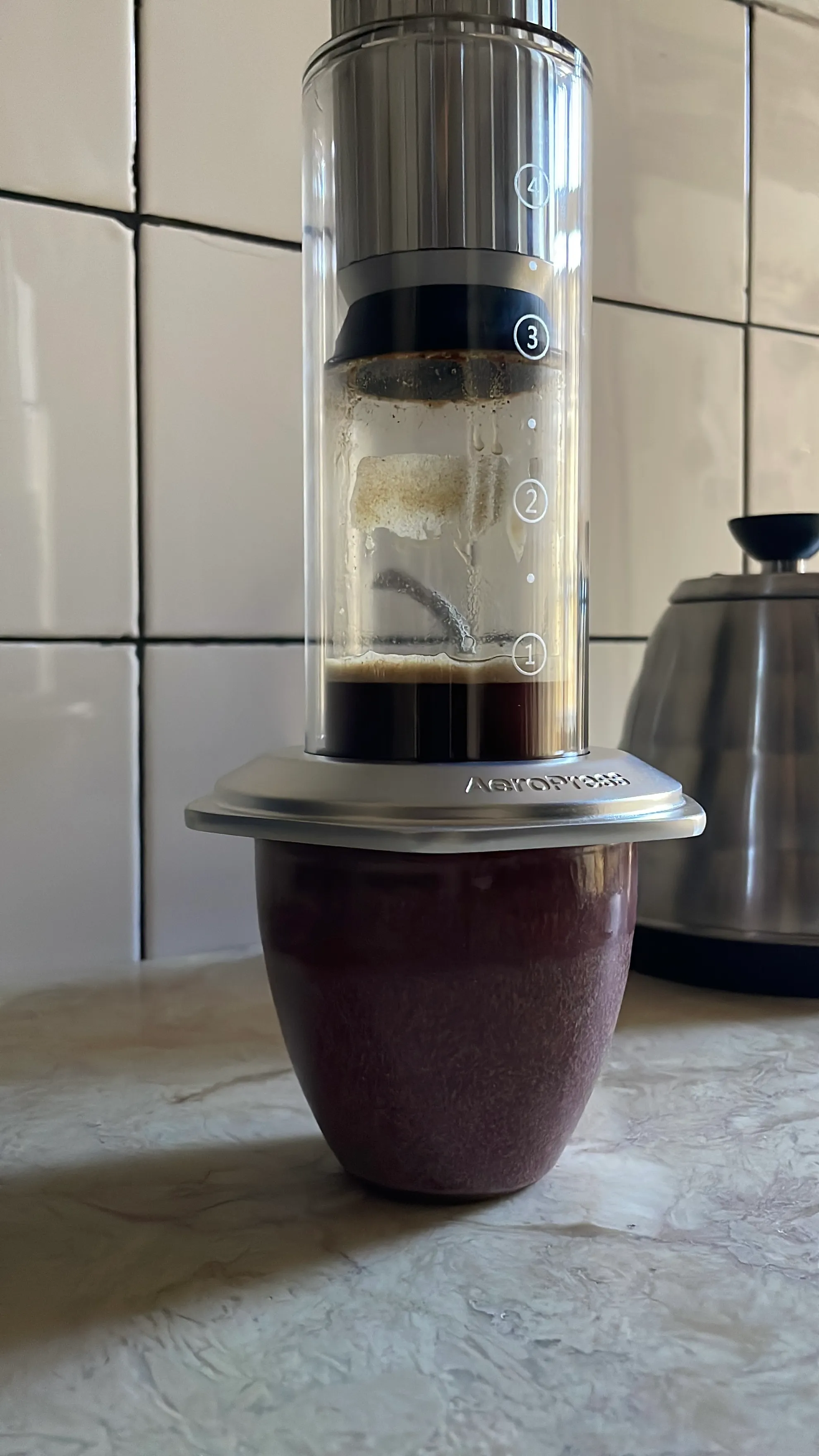 Up close of the Aeropress Premium brewing coffee in a home kitchen