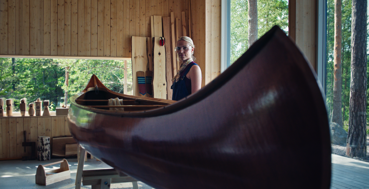 Slow living: A blonde lady hand crafts a canoe in Swedish cabin for Electrolux campaign with Publicis London. 