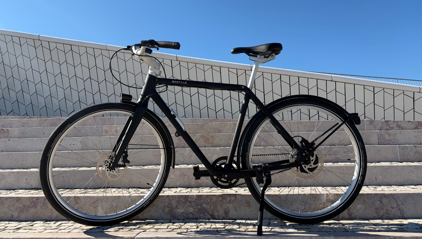 A side view of the Bastille E Bike on the side of the river cycle path in Lisbon.