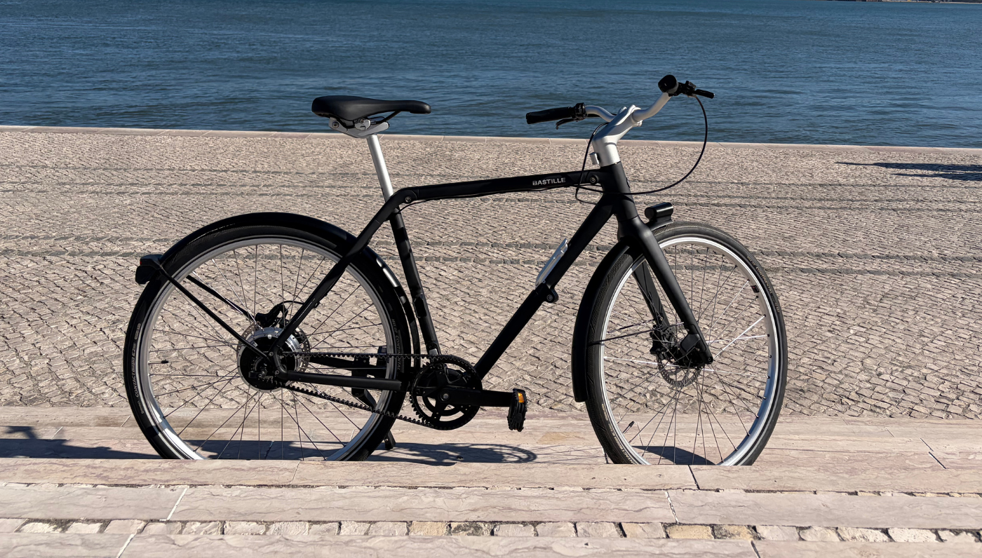 A side view of the Bastille E Bike on the side of the river cycle path in Lisbon, belt drive side.